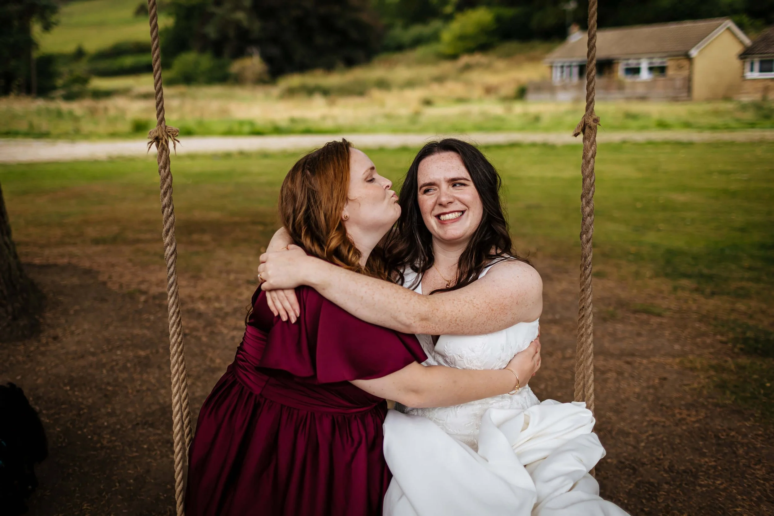 Bride and bridesmaid on a swing at the wedding