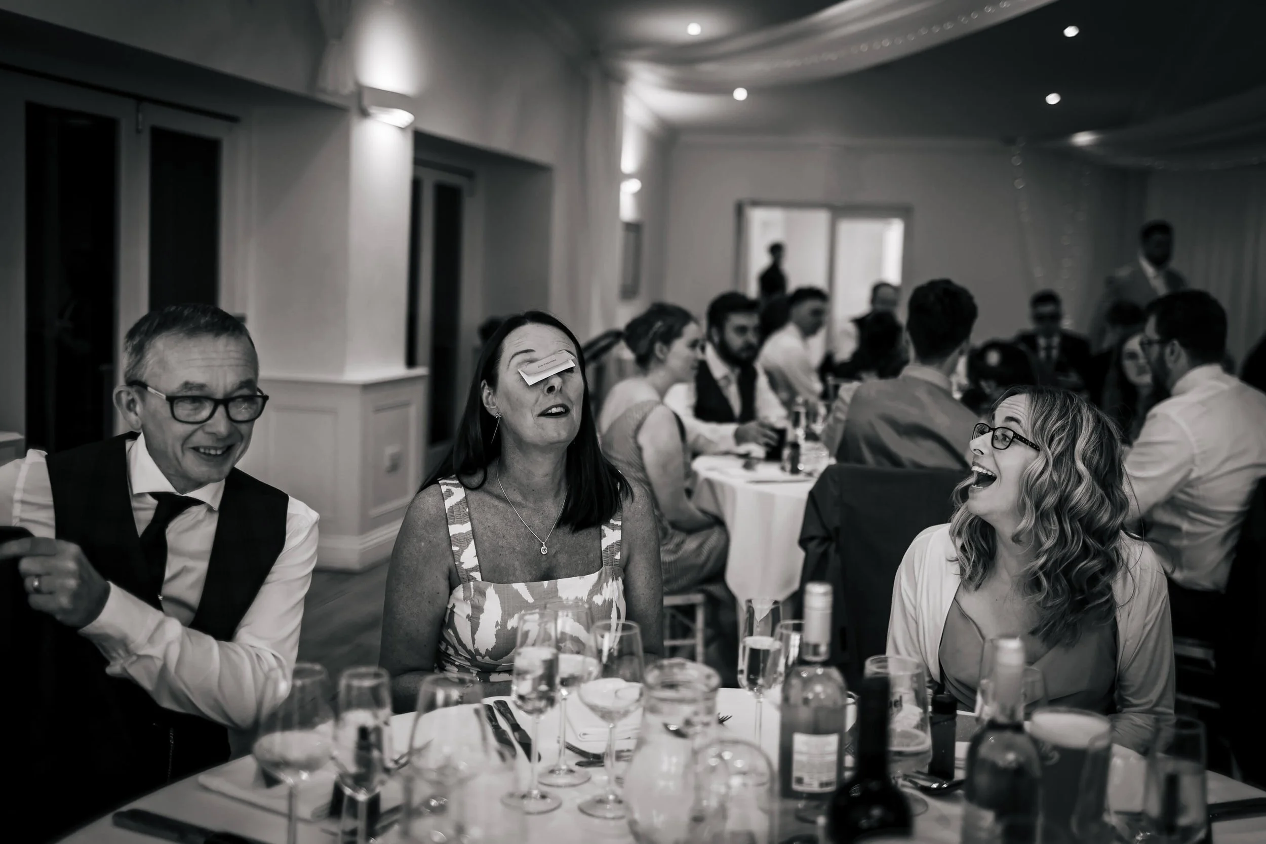 Wedding guests being silly at the tables before the speeches