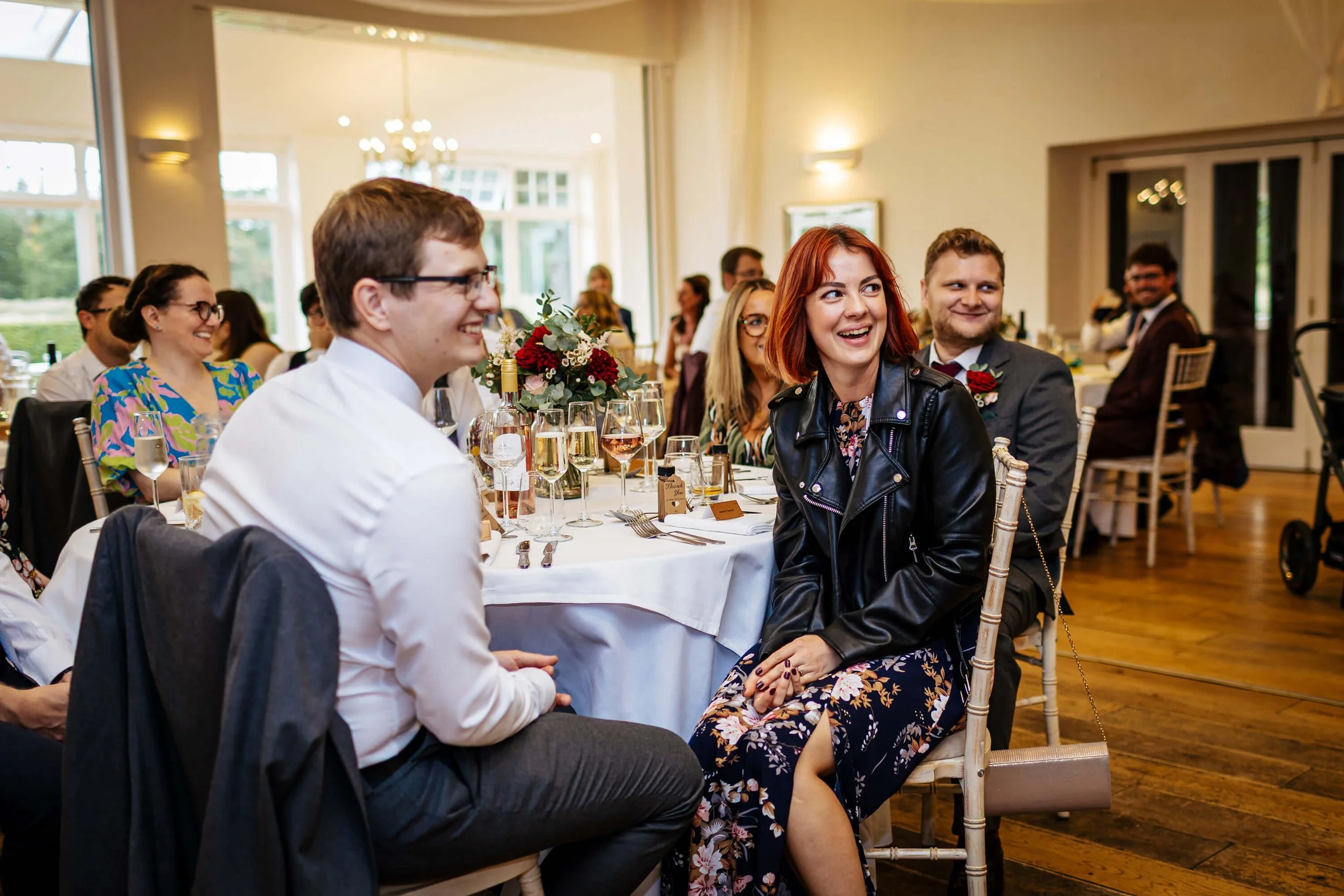 Wedding guests laughing during the speeches