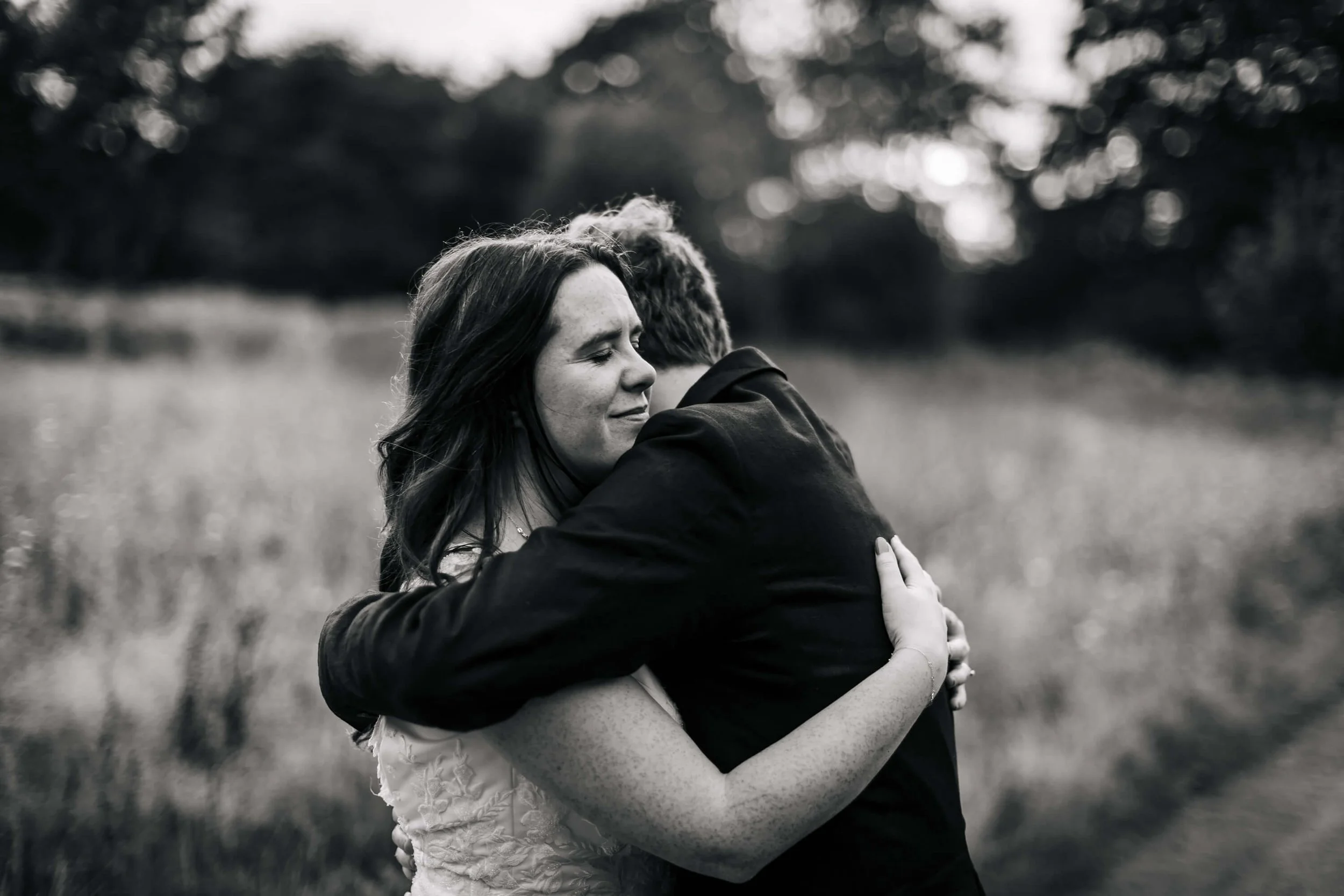Big hugs at a wedding with the bride and groom