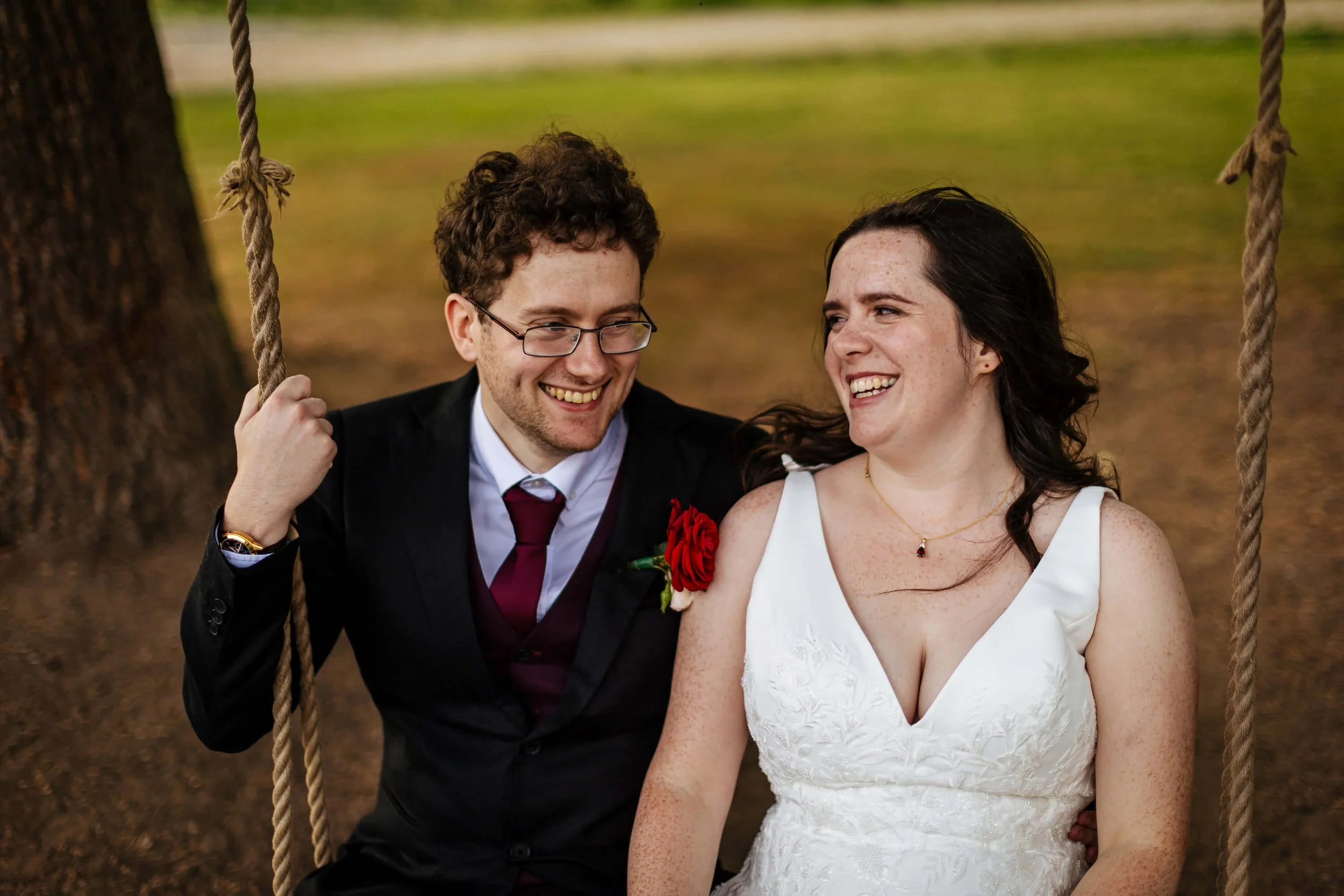 Bride and groom share a swing on their wedding day