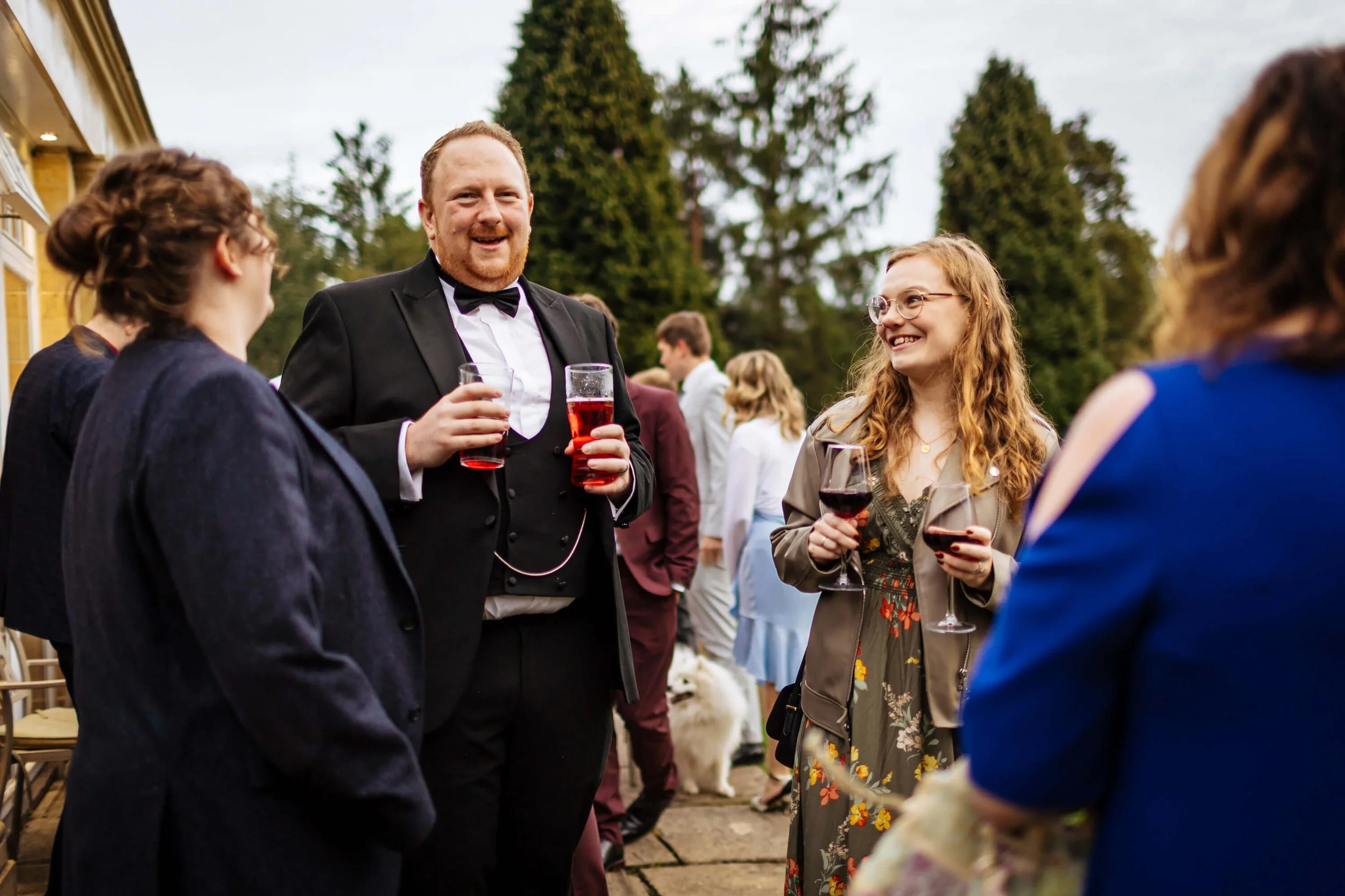 Wedding guests laughing in the grounds of Hackness Grange