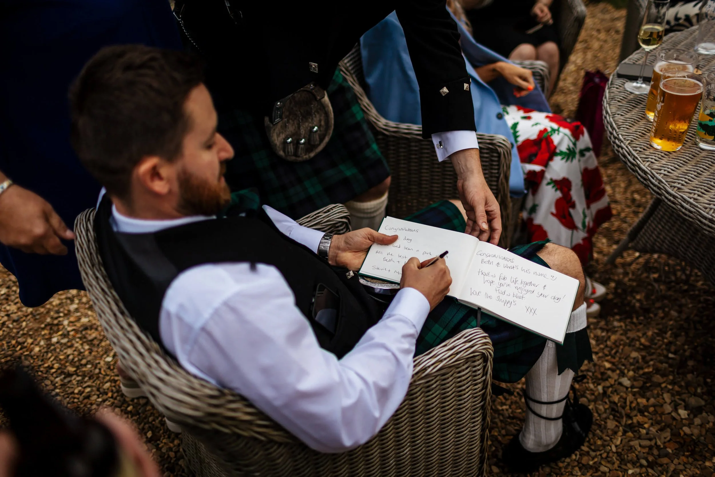 Wedding guest signing the guestbook 