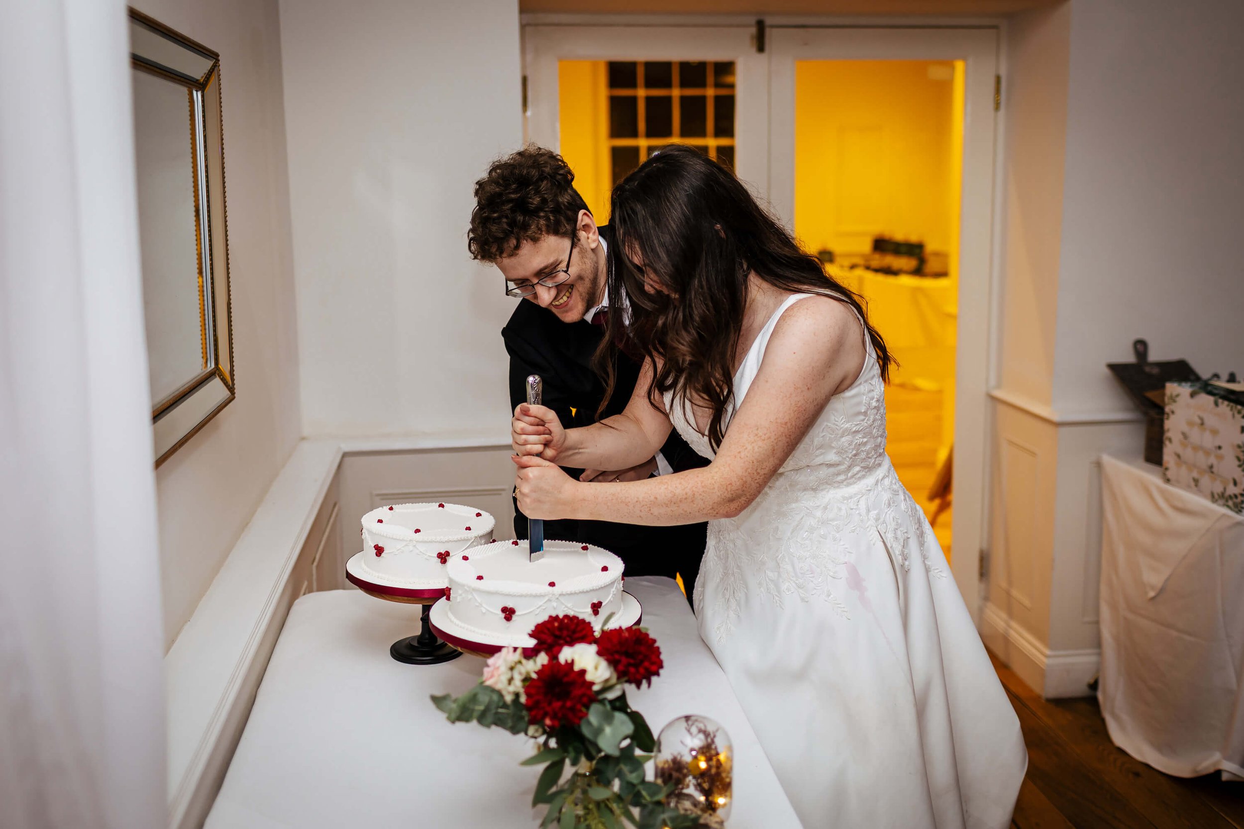 Bride and groom stab the wedding cake