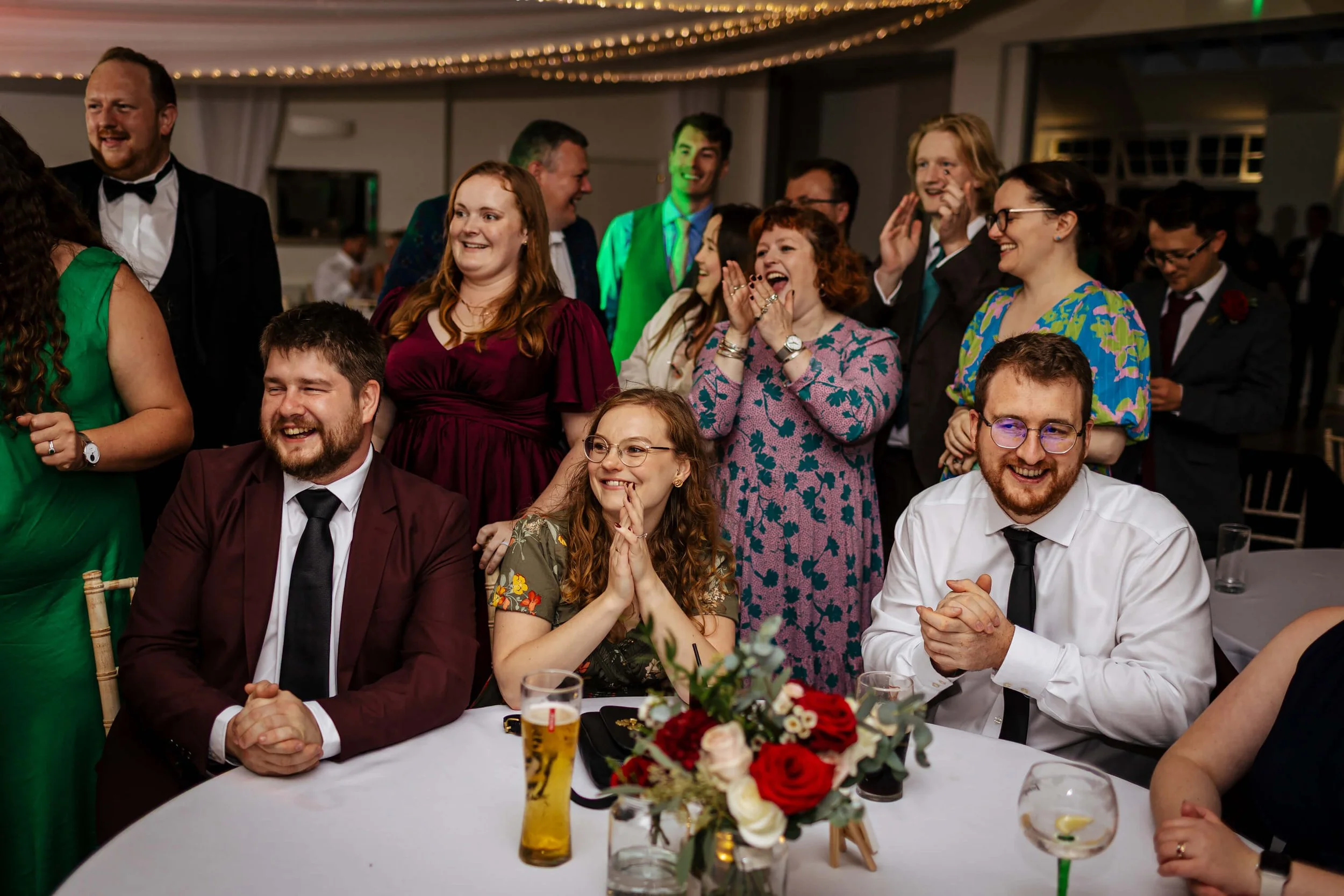 Wedding guests taking photos as the couple cut their cake