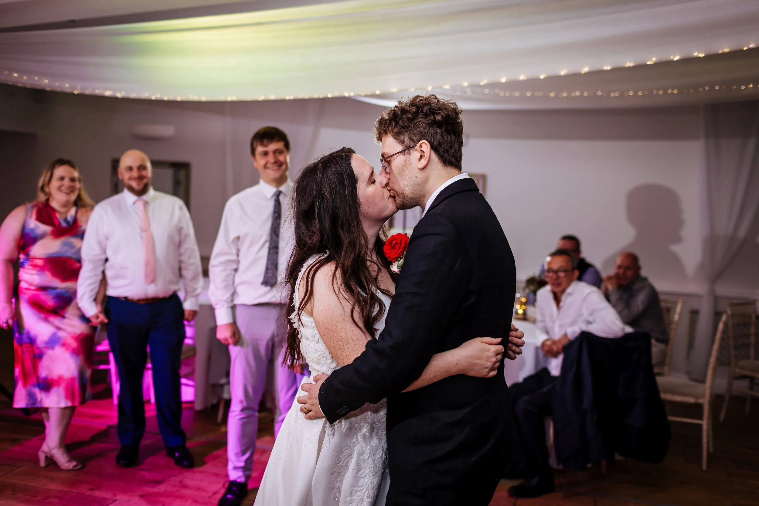 Newlywed couple share a kiss during their first dance