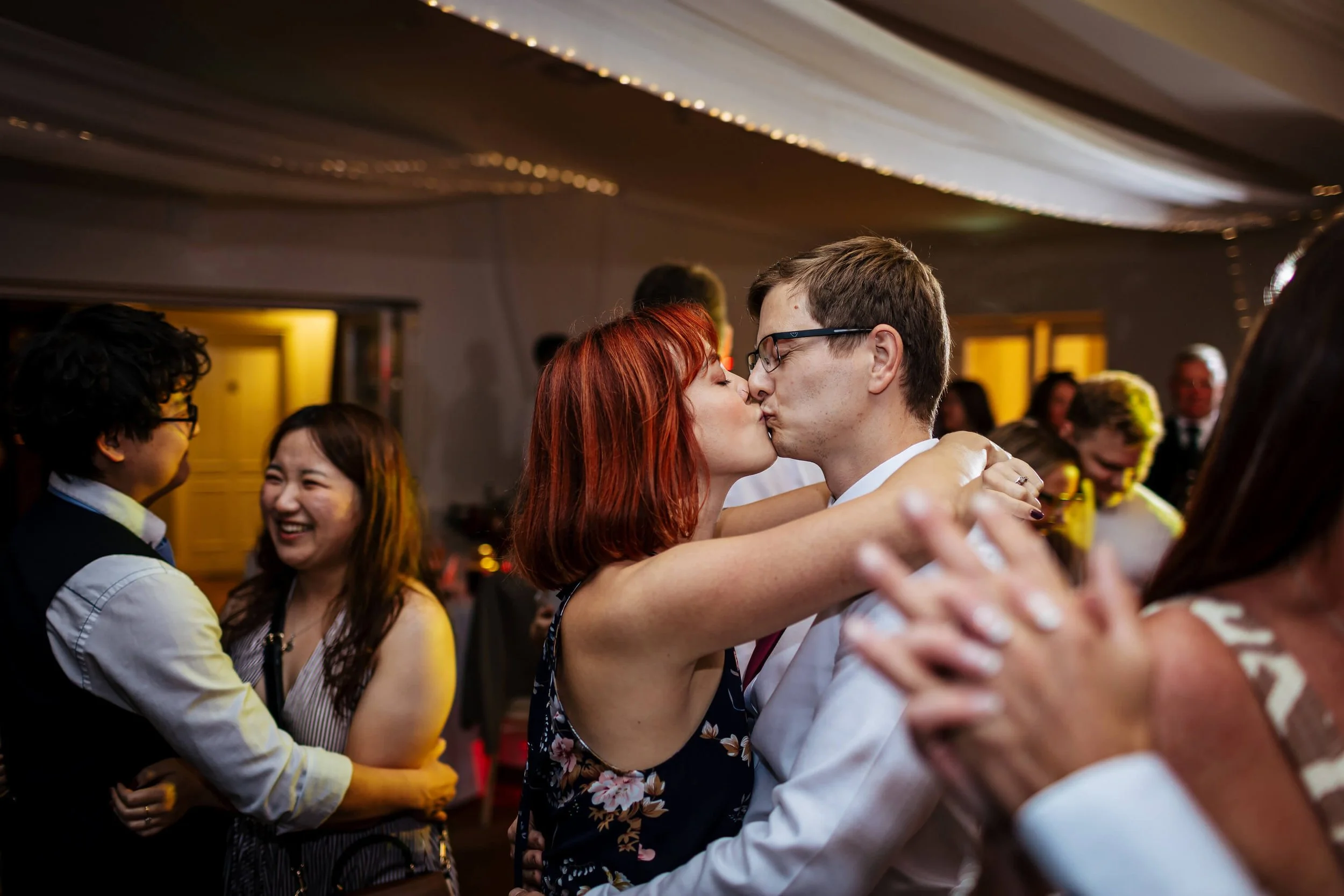 Wedding guests have a kiss on the dance floor in Yorkshire