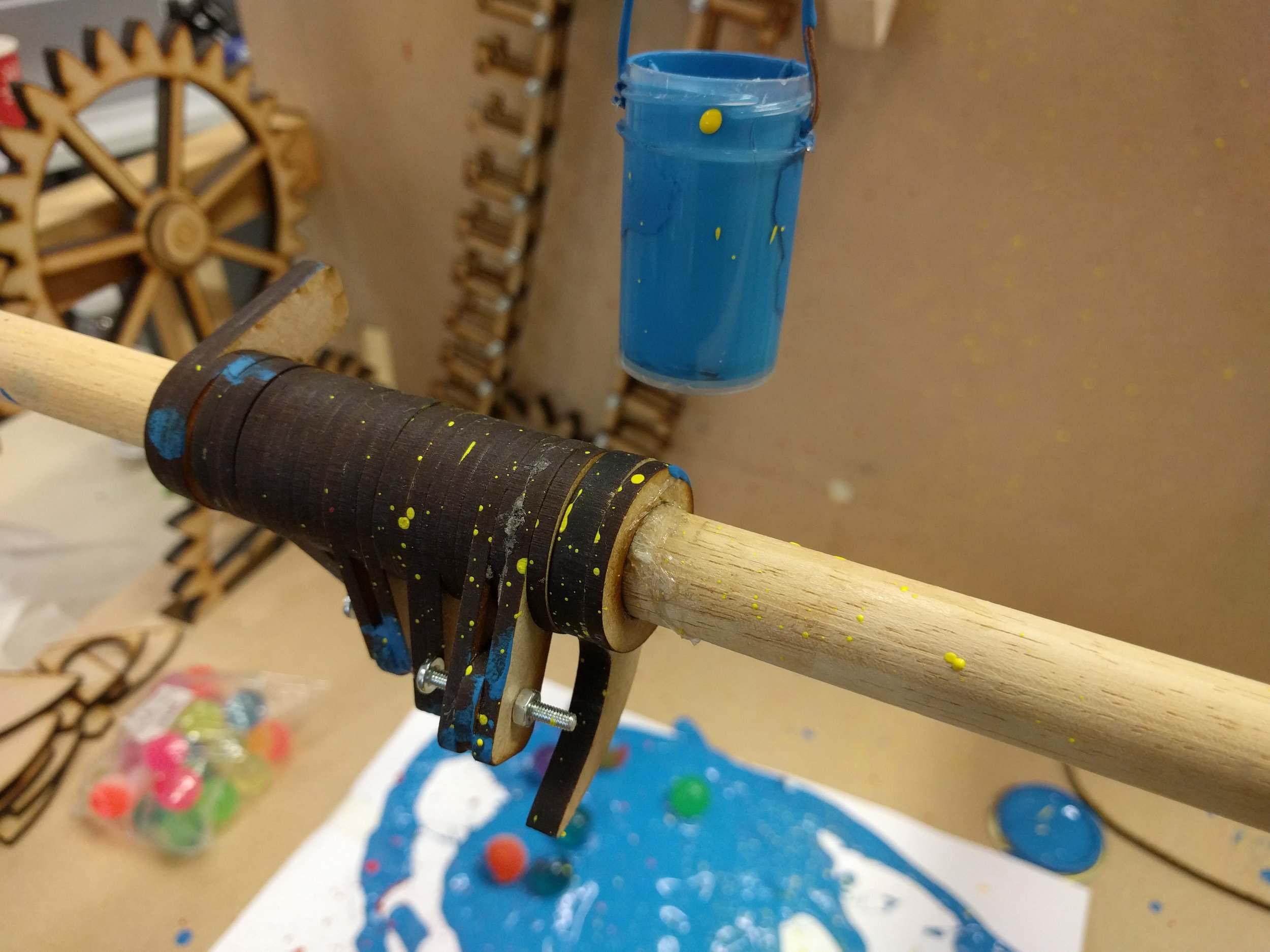 Time delay mechanism inspired by bank vaults coincides with music to tip the paint bucket at the very end