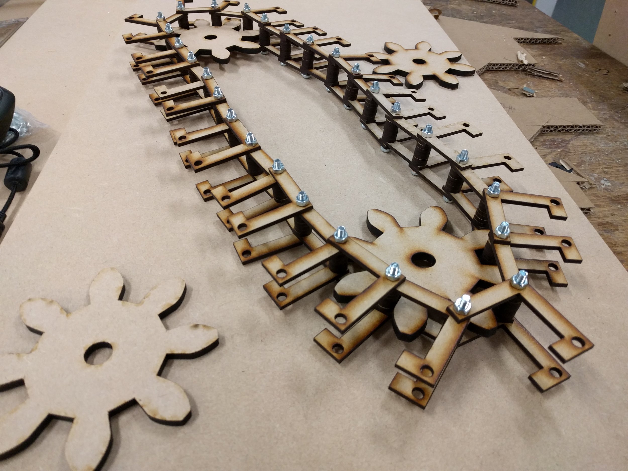 Belt mechanism drops balls onto paper as it turns to create patterns