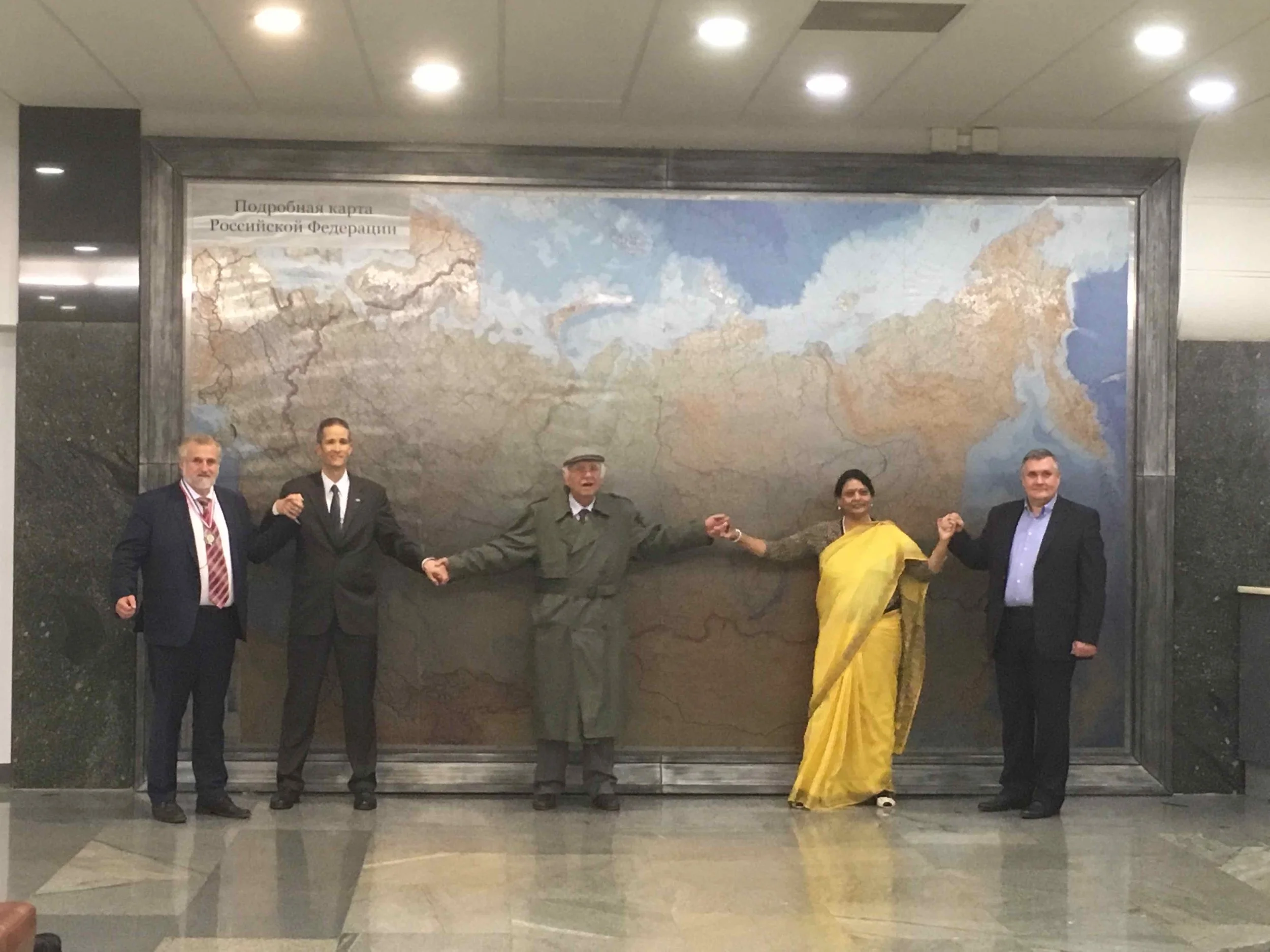 The InterContinental Railway team with their new friends in front of a giant map of Russia at the Russian State Duma.