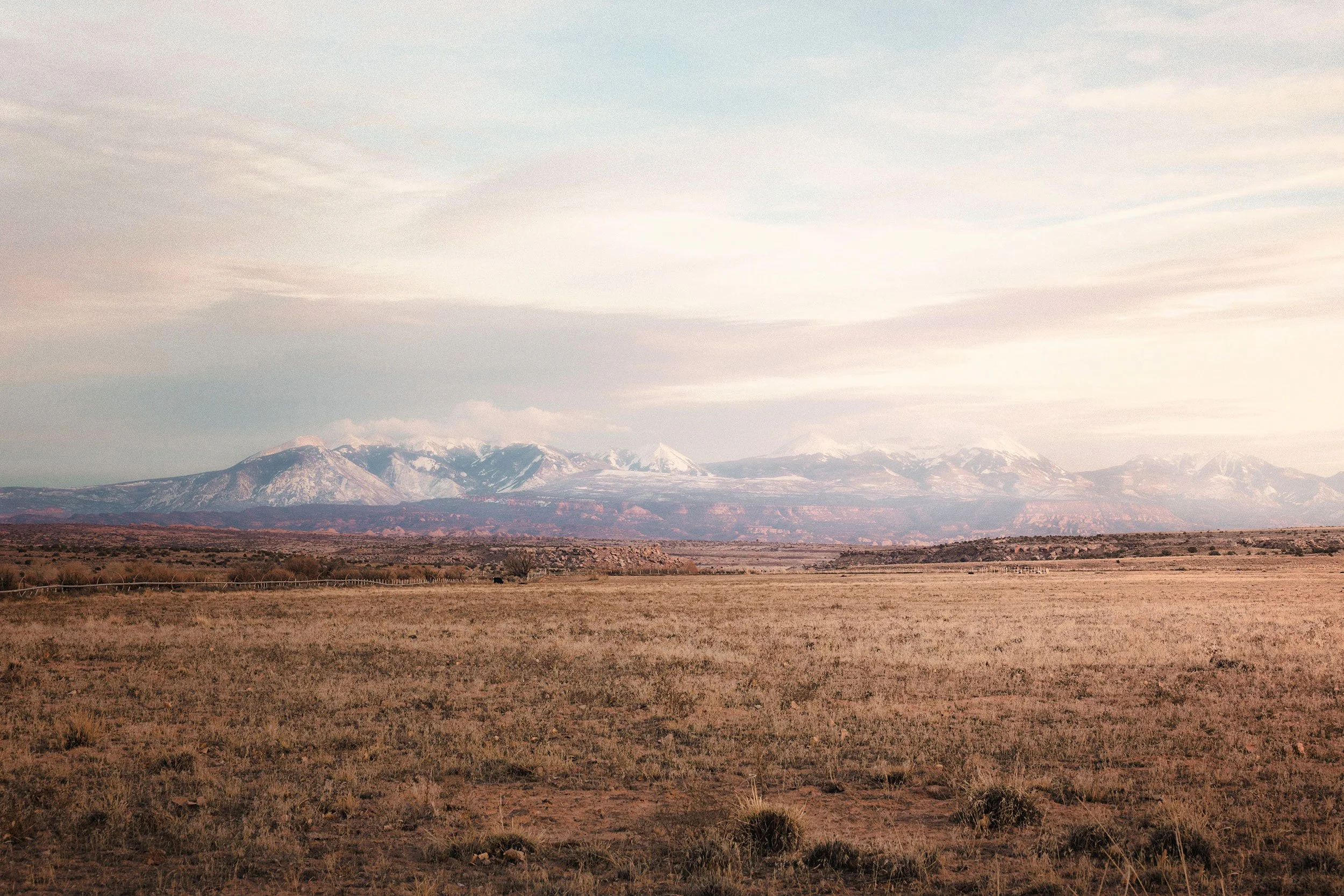 Sunset light over rugged mountain peaks in Utah, by Ryan L. Smith