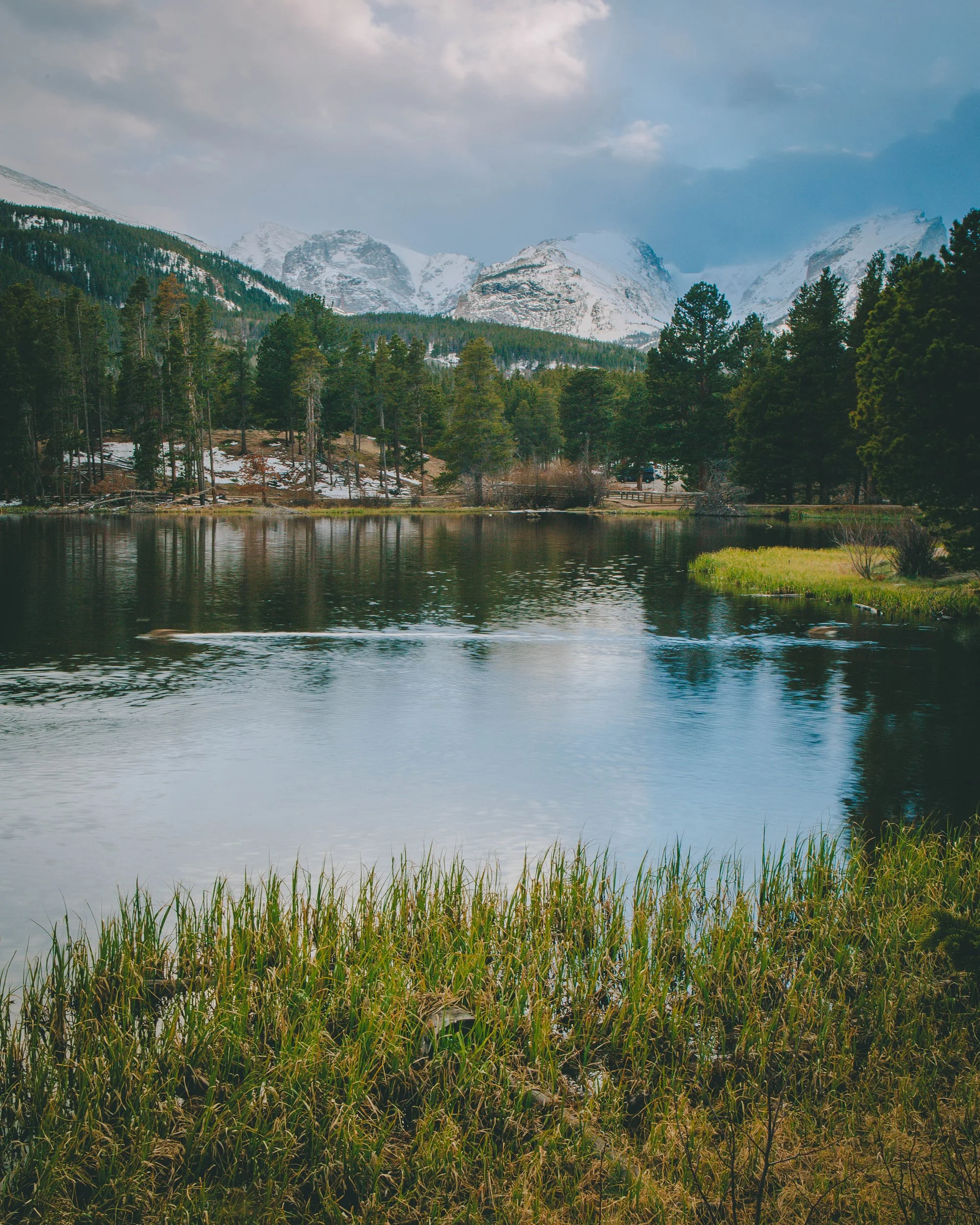 Moody winter light over snow capped peaks at Sprague Lake, Rocky Mountain National Park, Colorado, by Ryan L. Smith