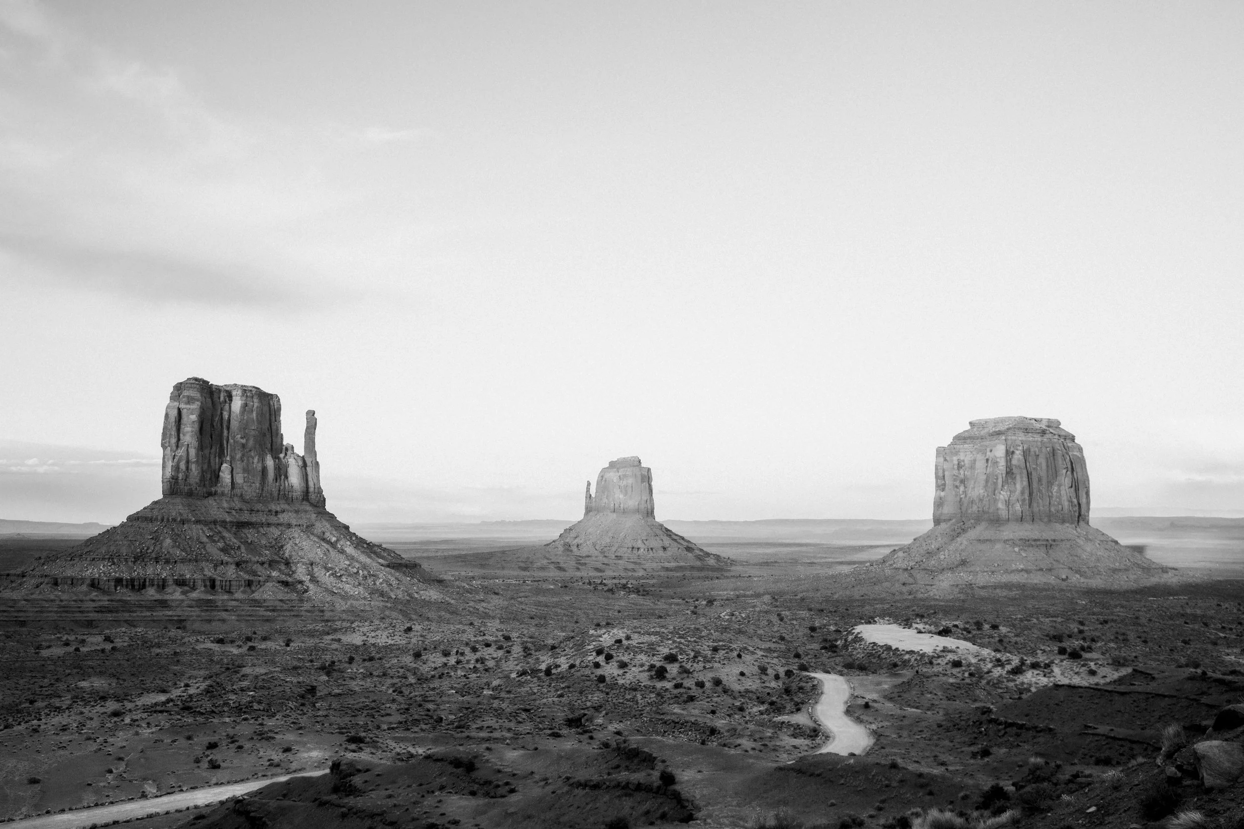 Black and white photograph of the sandstone buttes of Monument Valley on the Arizona-Utah border, by Ryan L. Smith