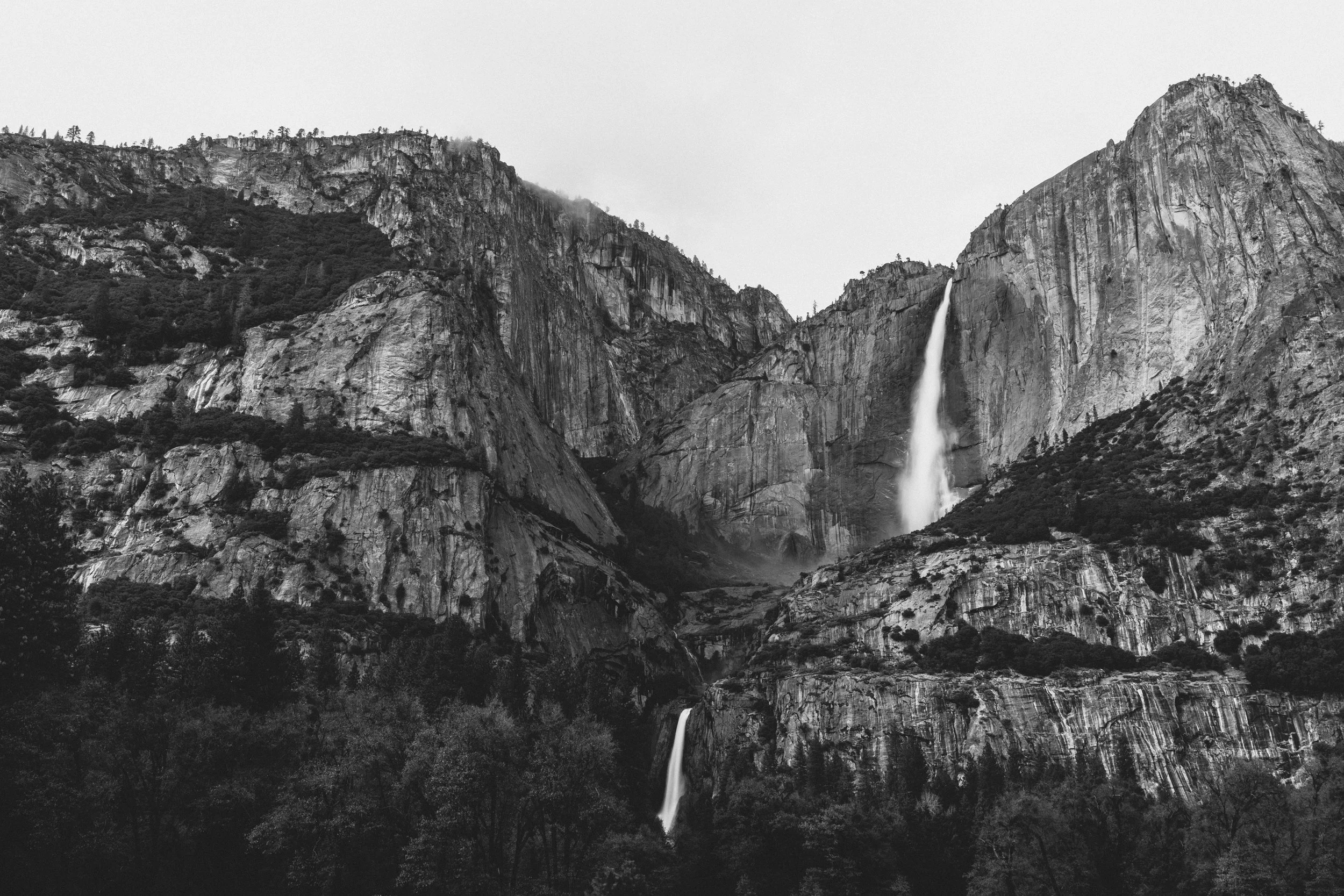 Black and white photograph of Yosemite Falls cascading down granite cliffs, Yosemite National Park, California, by Ryan L. Smith