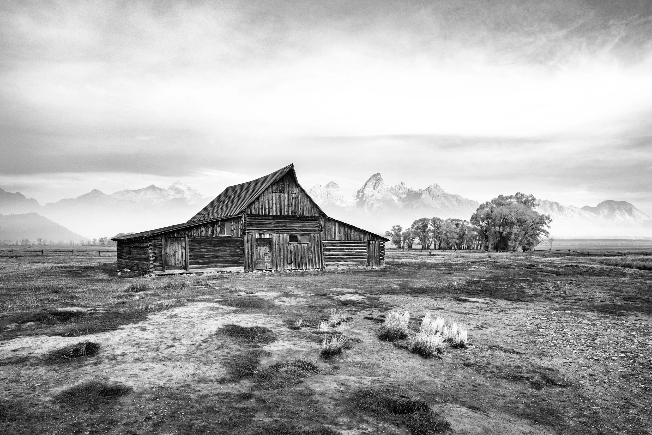 Black and white photograph of the T.A. Moulton Barn beneath the Teton Range, Mormon Row, Grand Teton National Park, Wyoming, by Ryan L. Smith