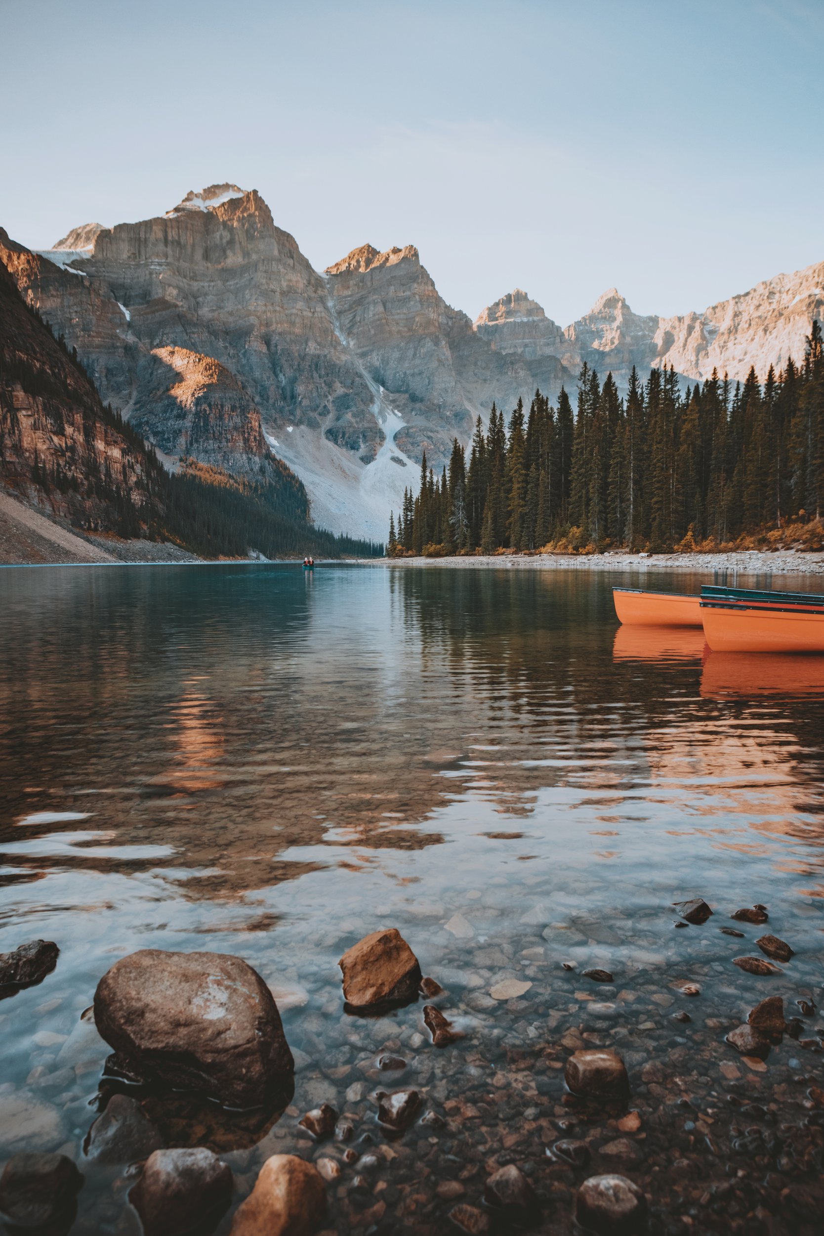 Canoes resting on the turquoise water of Moraine Lake below the Valley of the Ten Peaks, Banff National Park, Alberta, by Ryan L. Smith