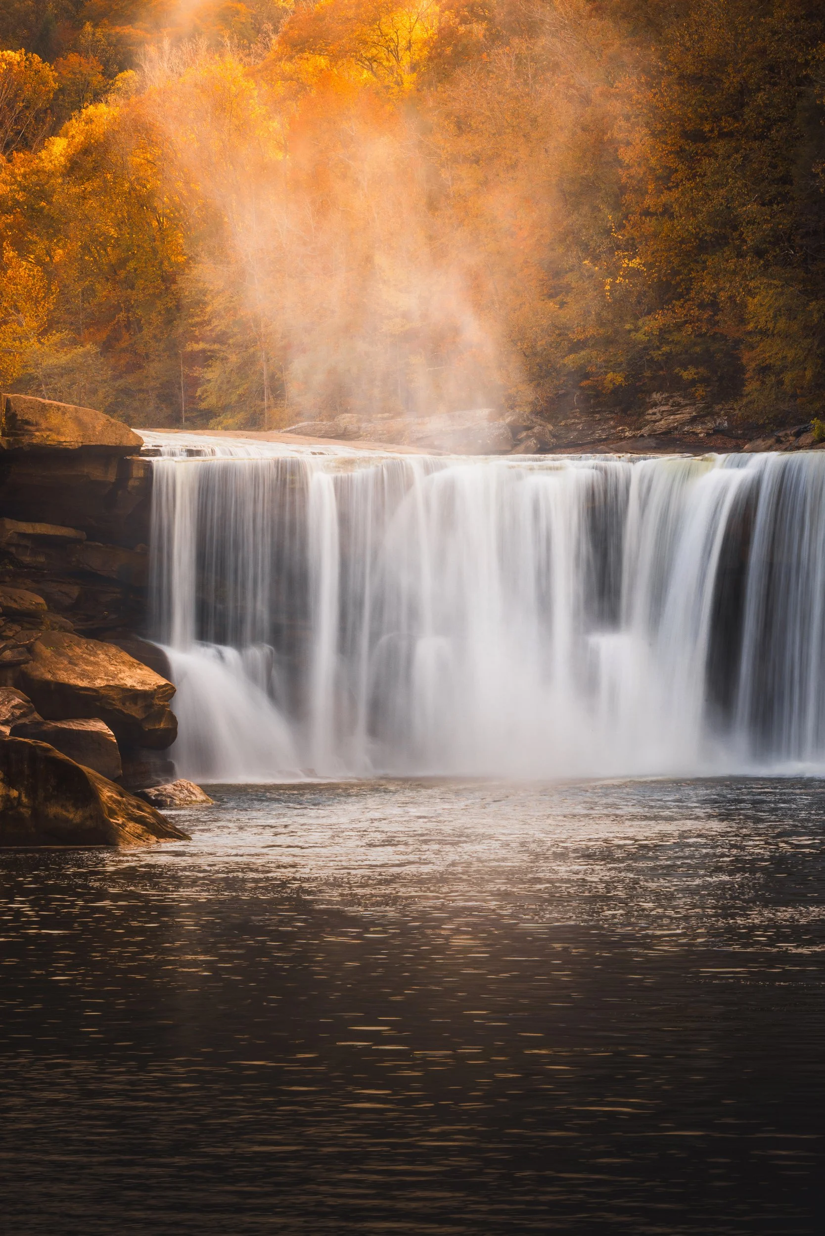 A close view of Cumberland Falls with autumn color rising behind it, Kentucky, by Ryan L. Smith