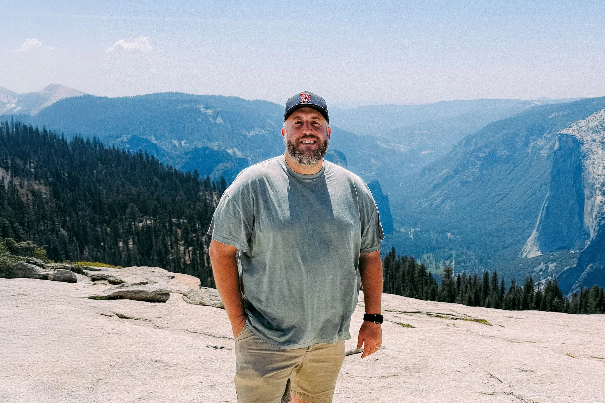 Ryan L. Smith standing at a mountain overlook in Yosemite National Park.