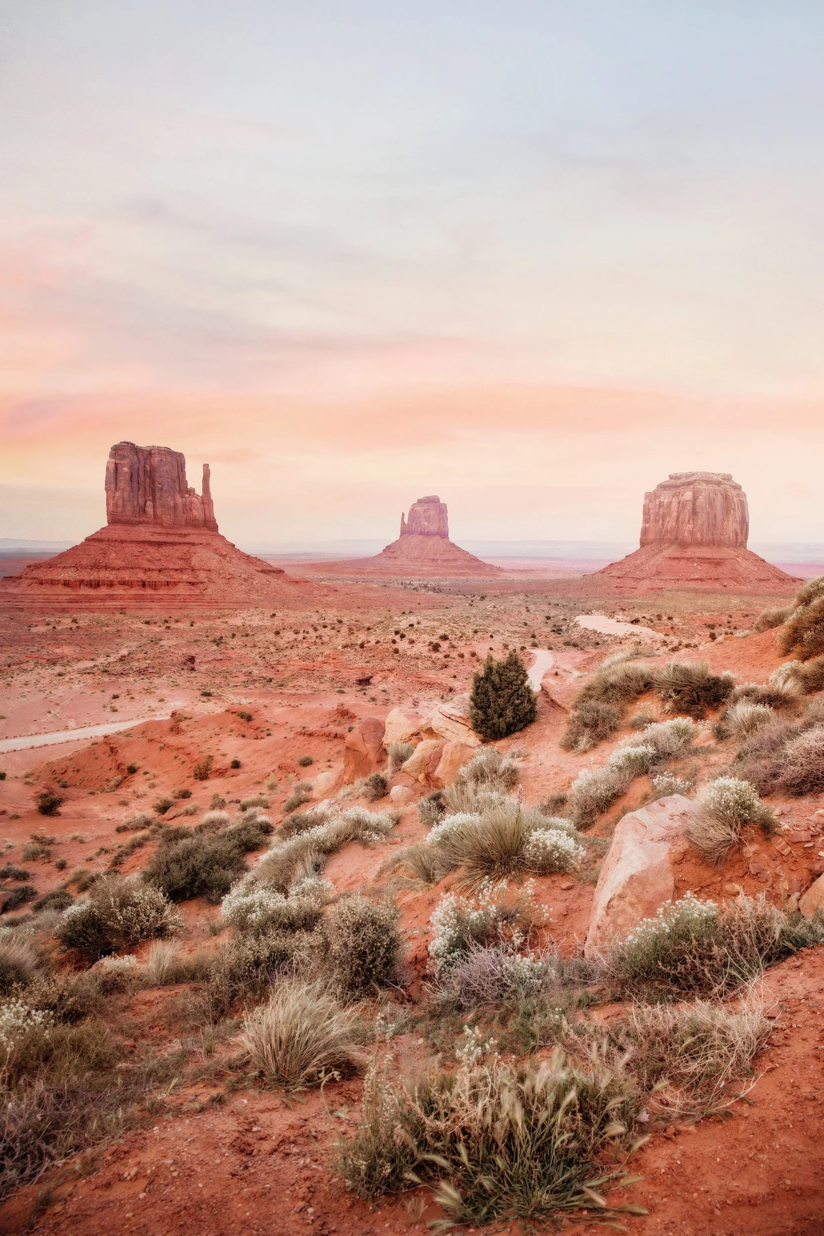 Warm sunset glow on the sandstone buttes of Monument Valley on the Arizona-Utah border, by Ryan L. Smith