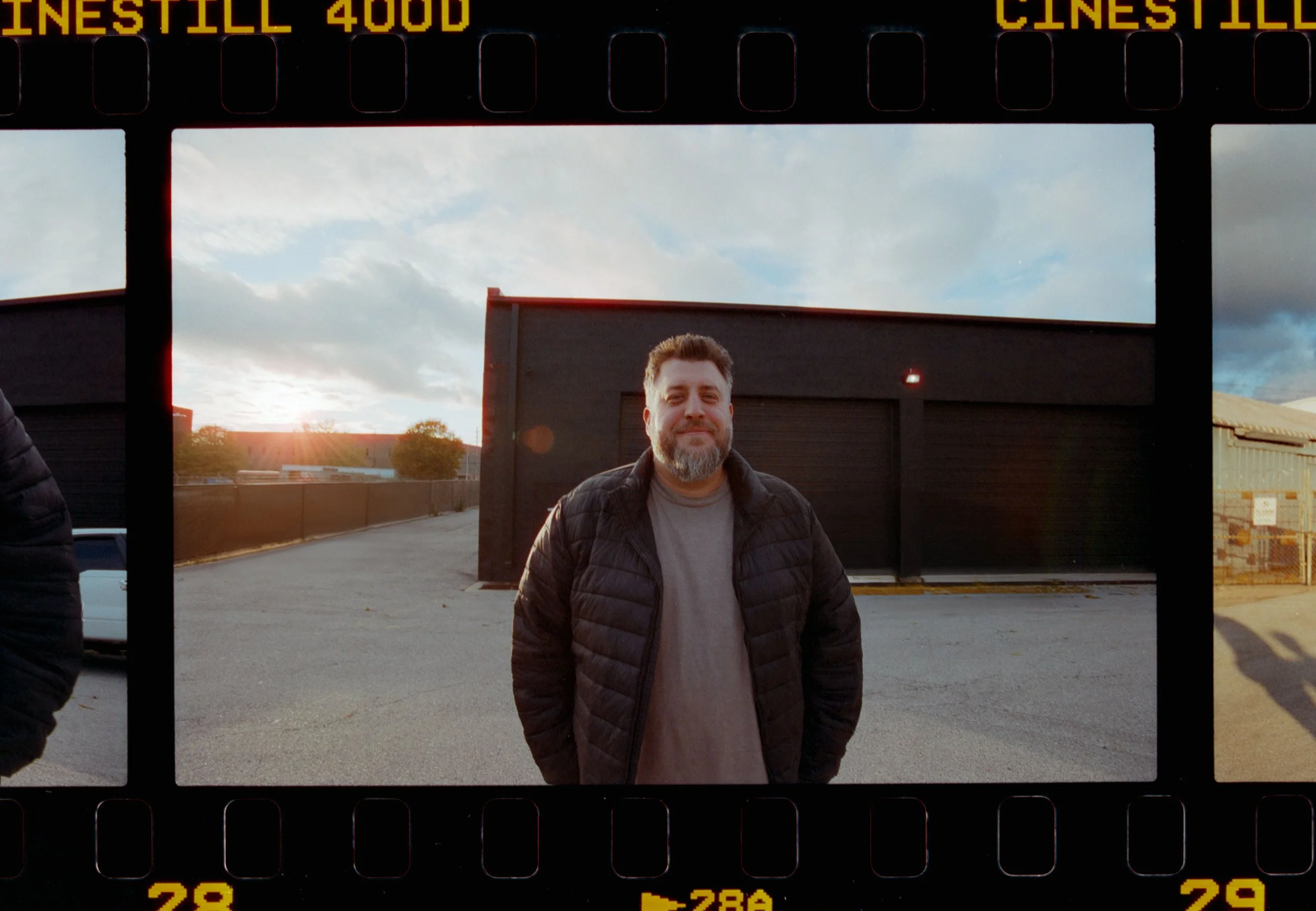 Portrait of Ryan L. Smith in a film-style frame outside a studio location.