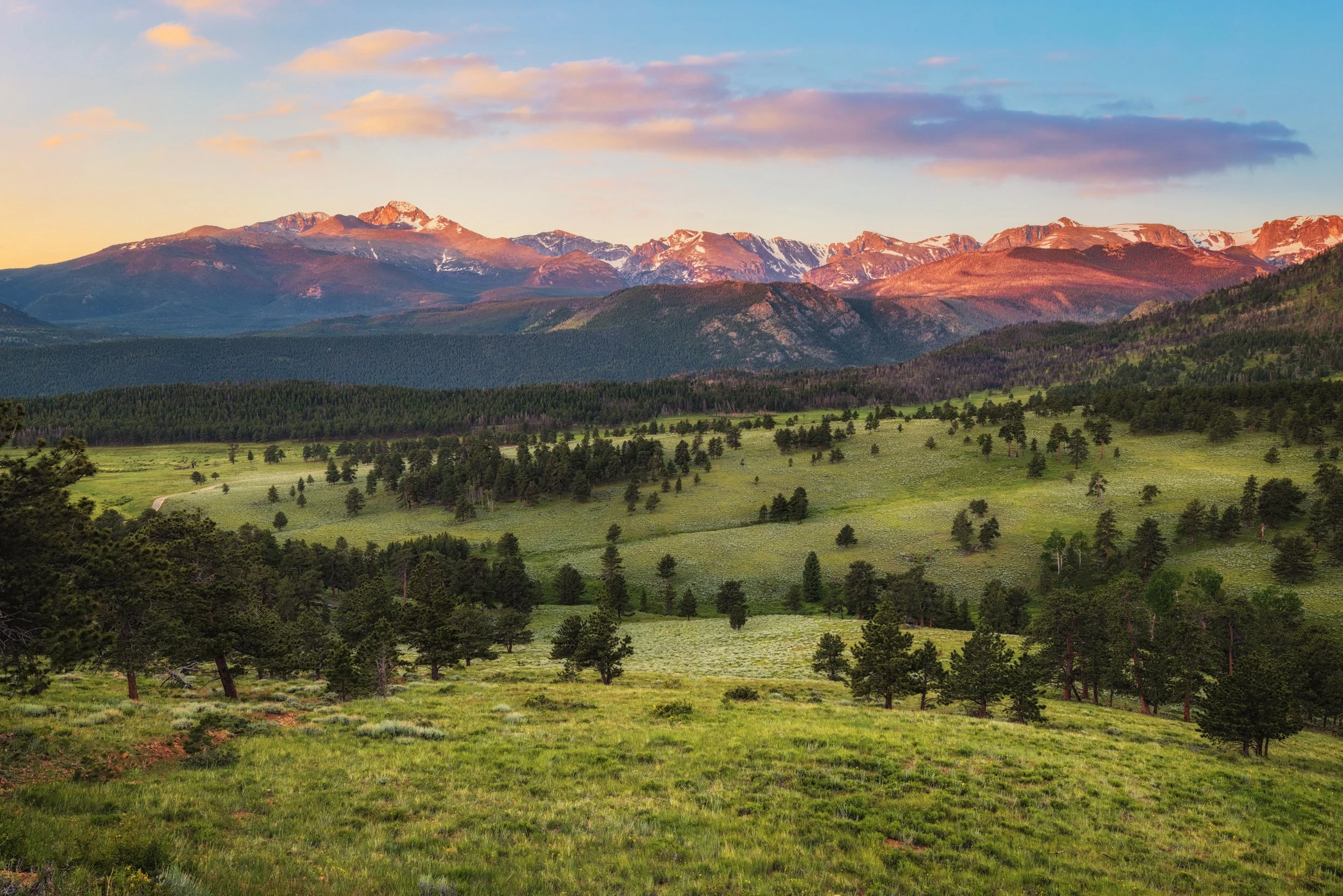 Alpenglow lighting up the peaks above Beaver Meadows at sunrise, Rocky Mountain National Park, Colorado, by Ryan L. Smith