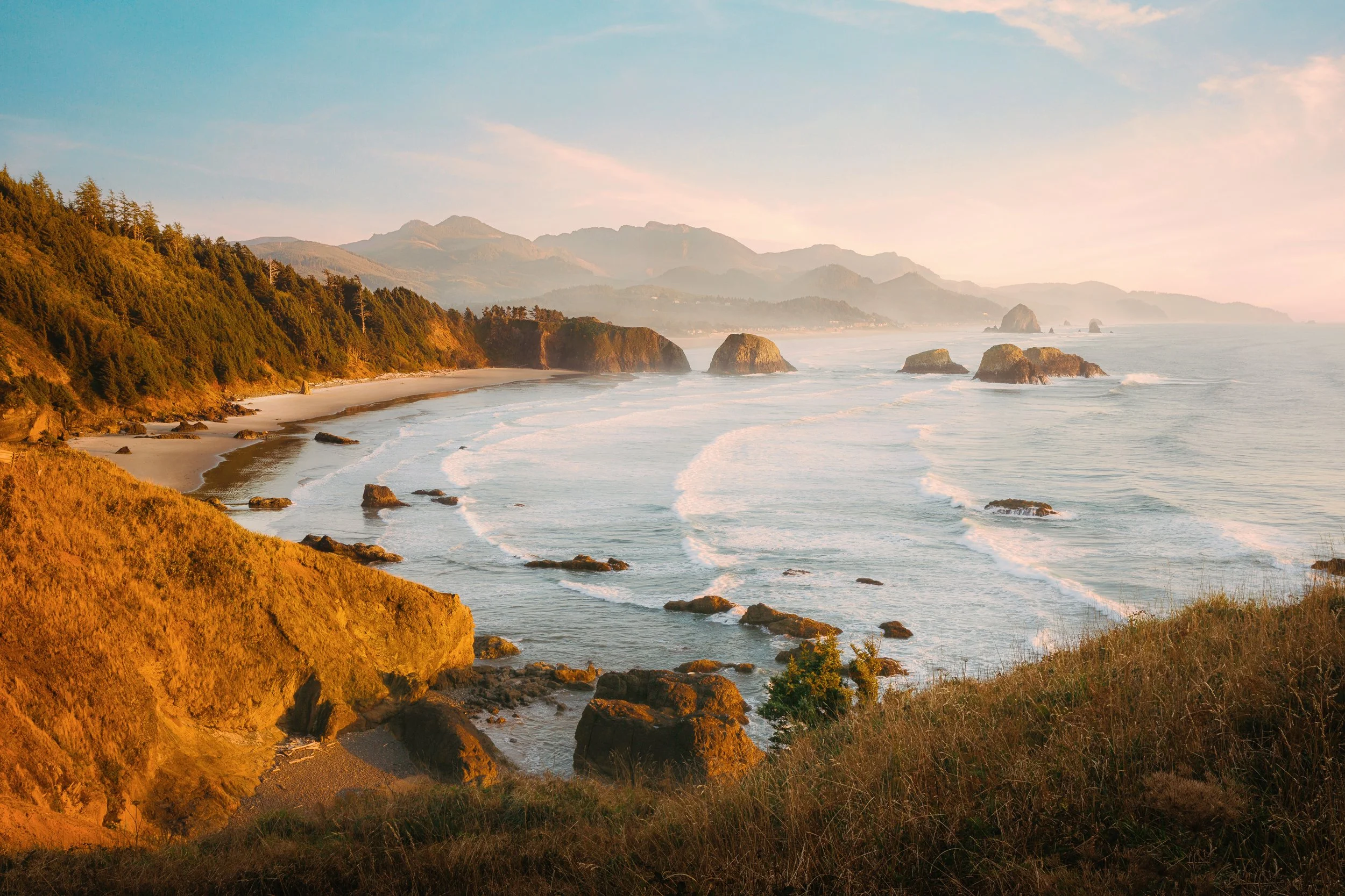 Warm evening glow over the headlands and sea stacks at Ecola State Park, Oregon coast, by Ryan L. Smith