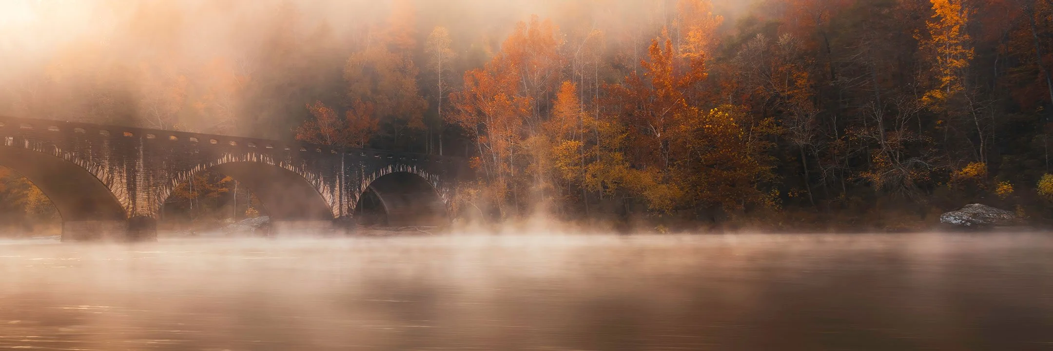 Morning fog rising around the Gatliff Memorial Bridge near Cumberland Falls, Kentucky, by Ryan L. Smith
