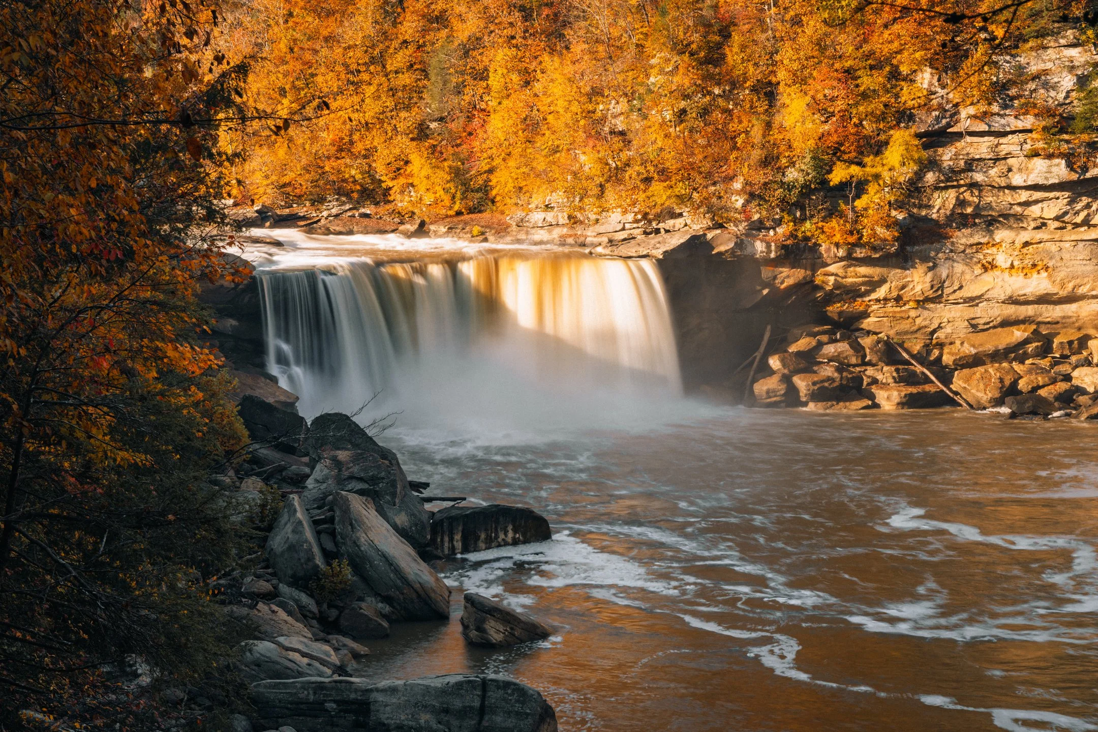 A closer view of Cumberland Falls in golden light from the walkway between the second and third viewing decks, Kentucky, by Ryan L. Smith