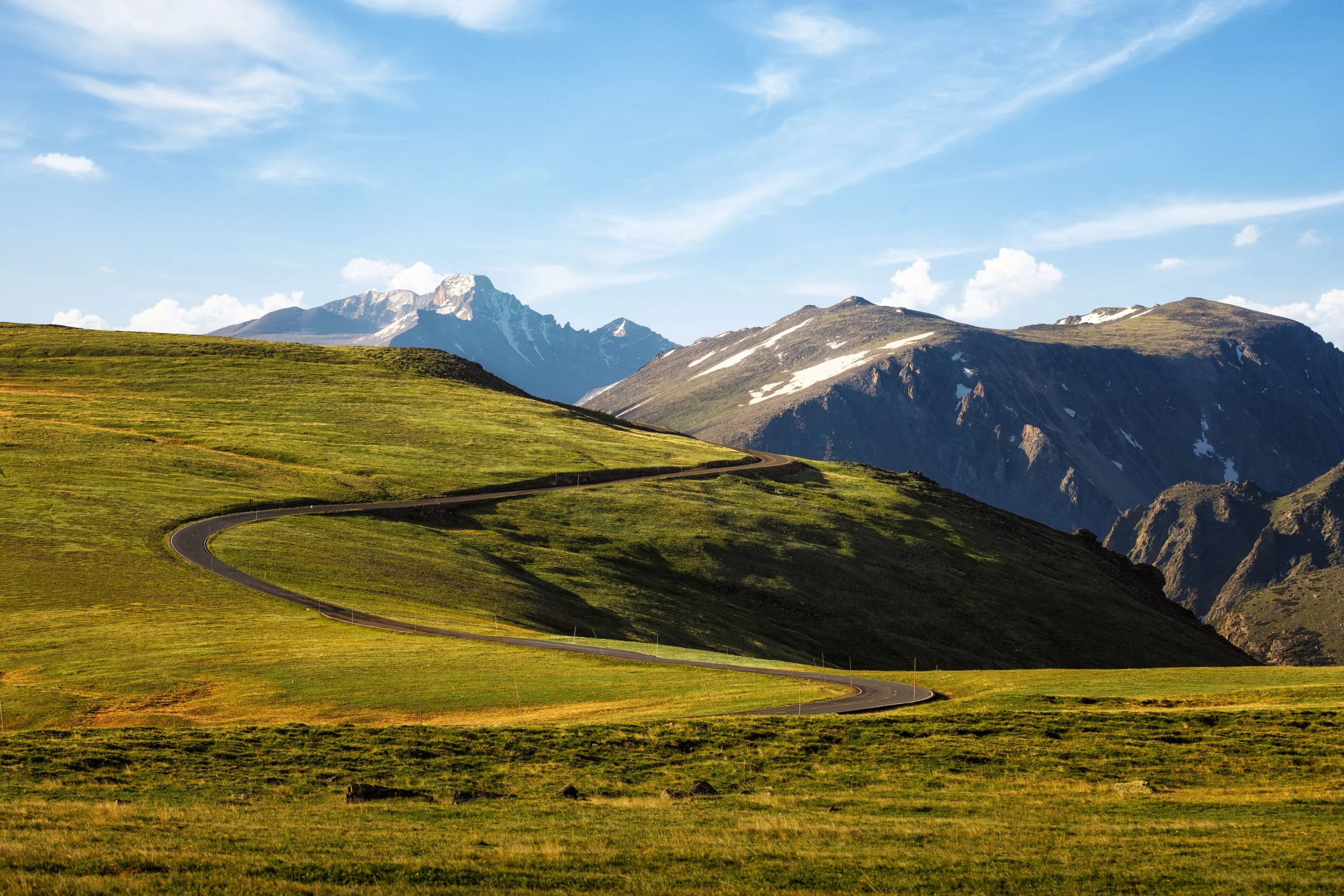 The winding road above treeline on Trail Ridge Road with distant snow capped peaks, Rocky Mountain National Park, Colorado, by Ryan L. Smith