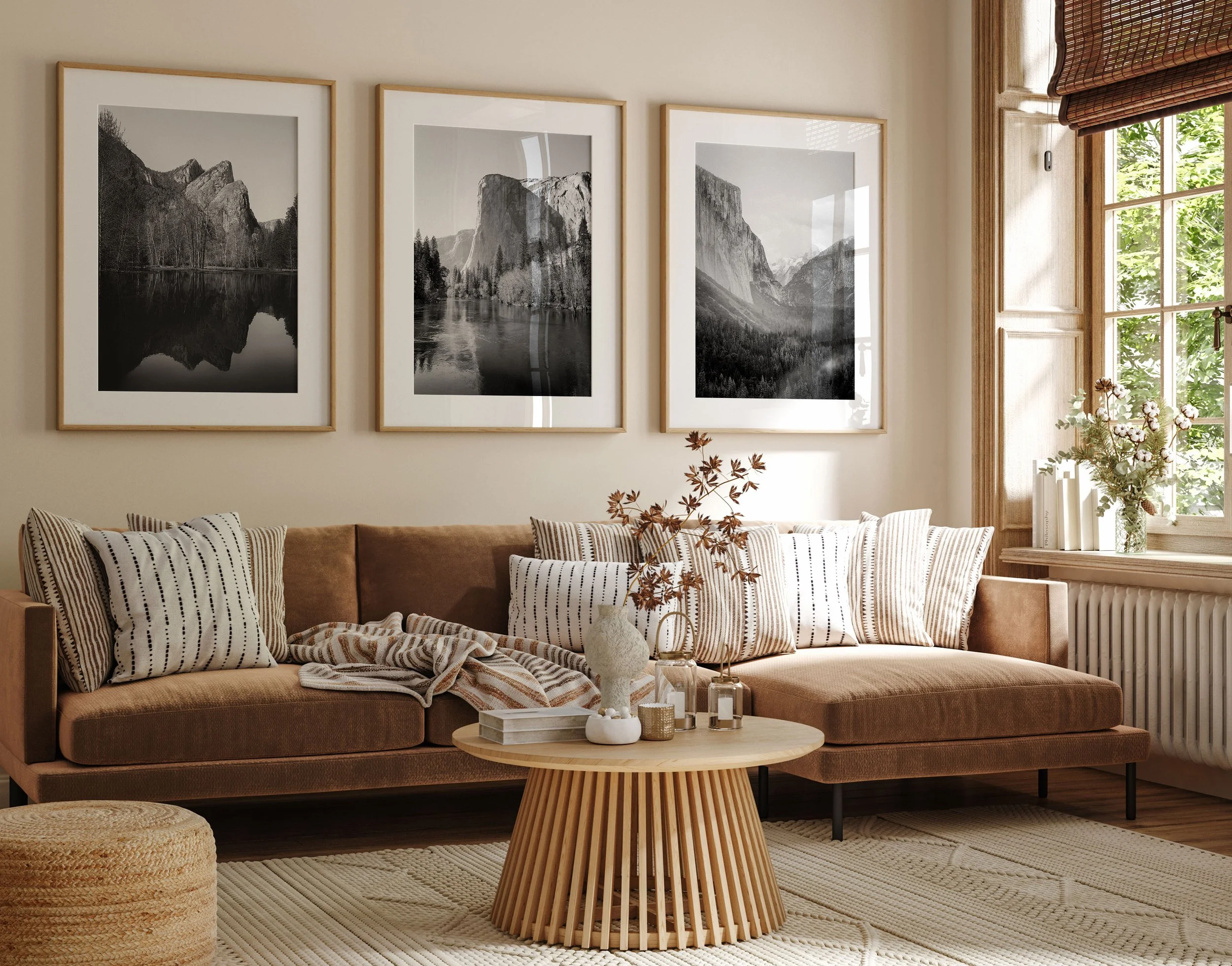 Framed black and white Yosemite landscape prints displayed above a modern living room sofa.