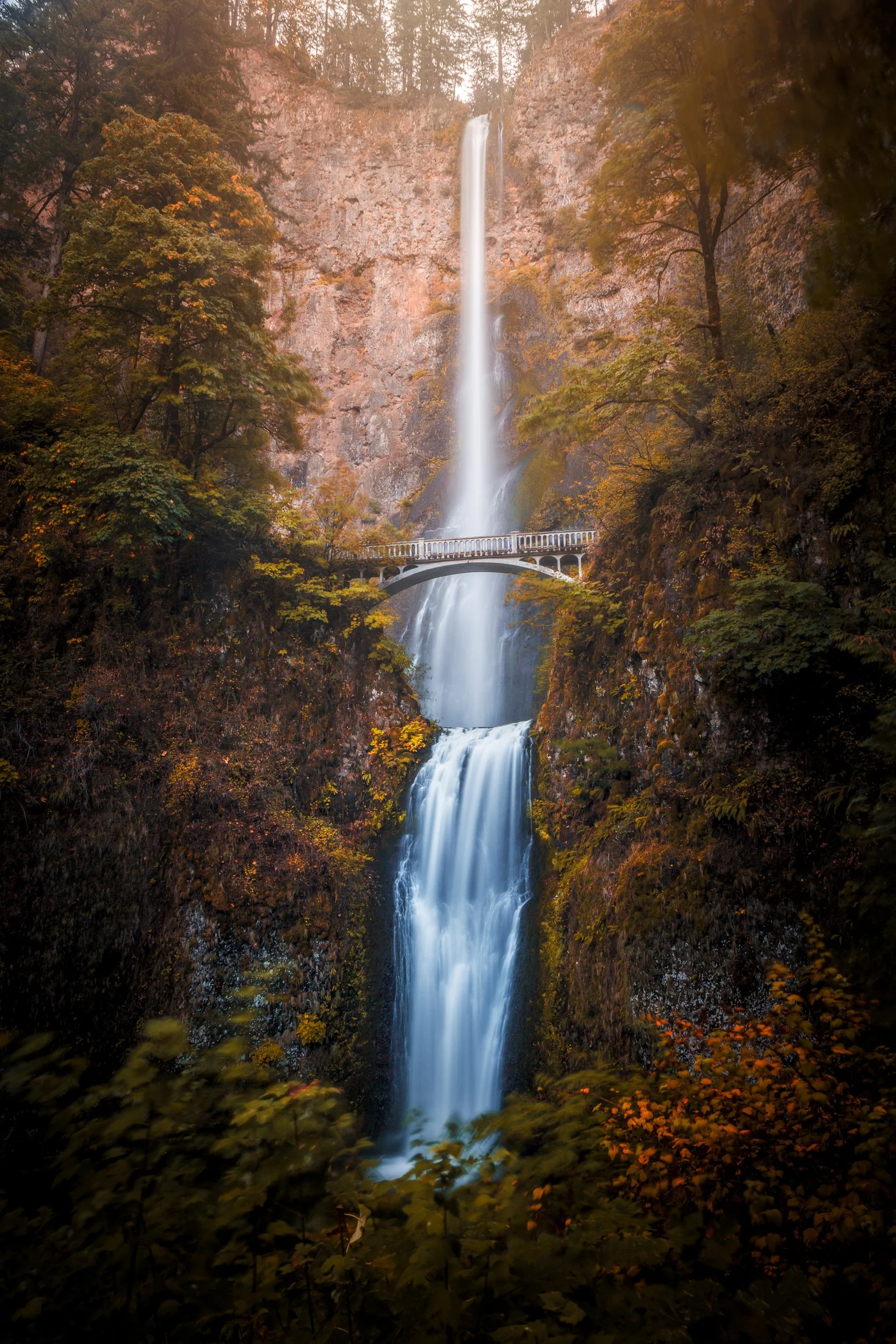 Multnomah Falls cascading through a misty forest in the Columbia River Gorge, Oregon landscape photography by Ryan L. Smith