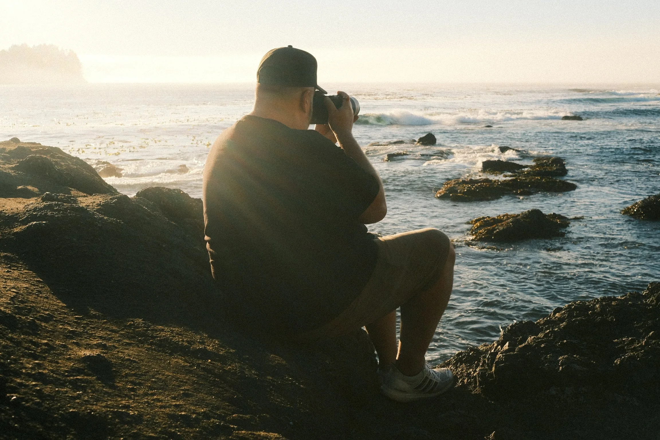 Ryan L. Smith photographing the coastline during golden hour.