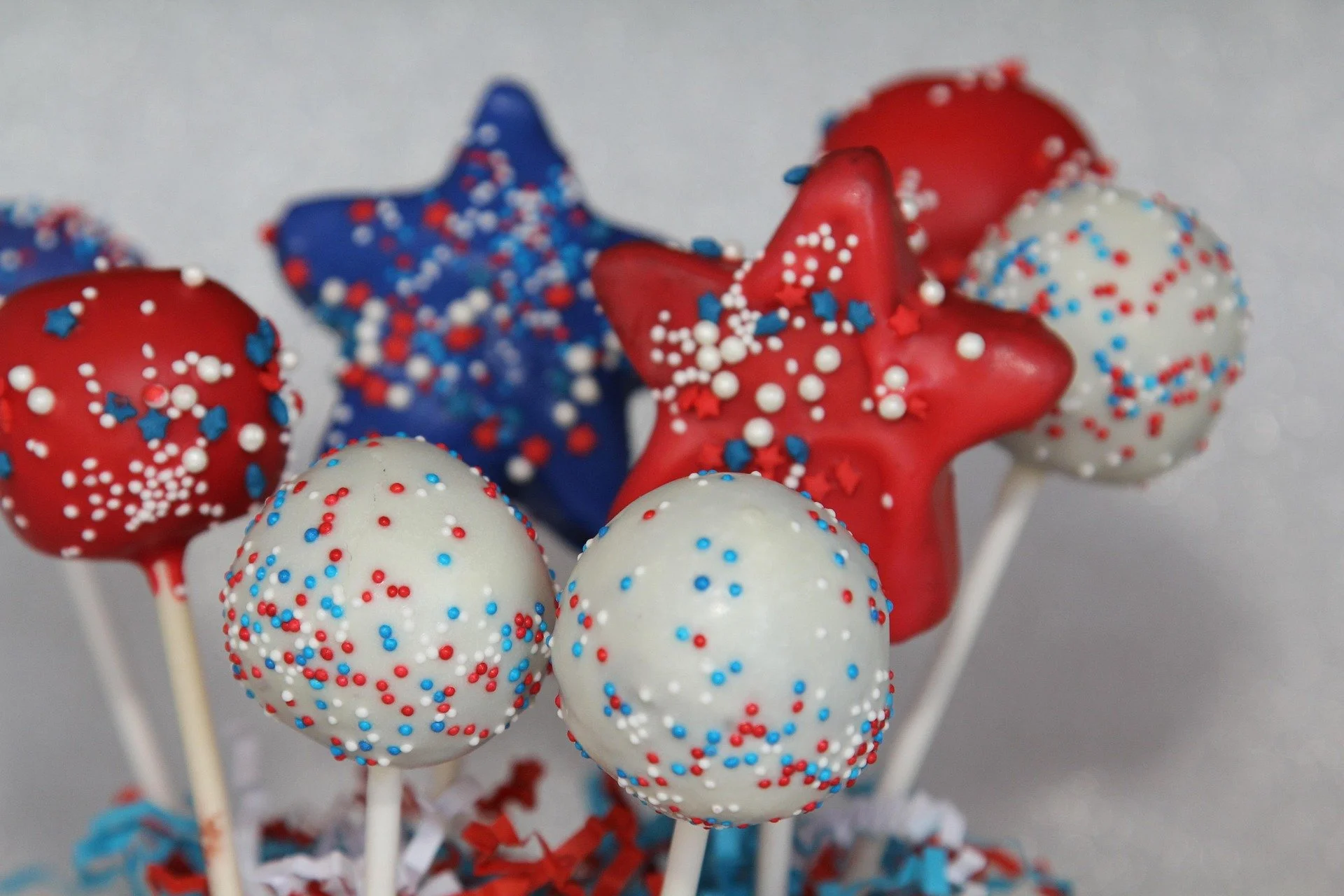 Red, white, and blue cake pops in the shape of balls and stars