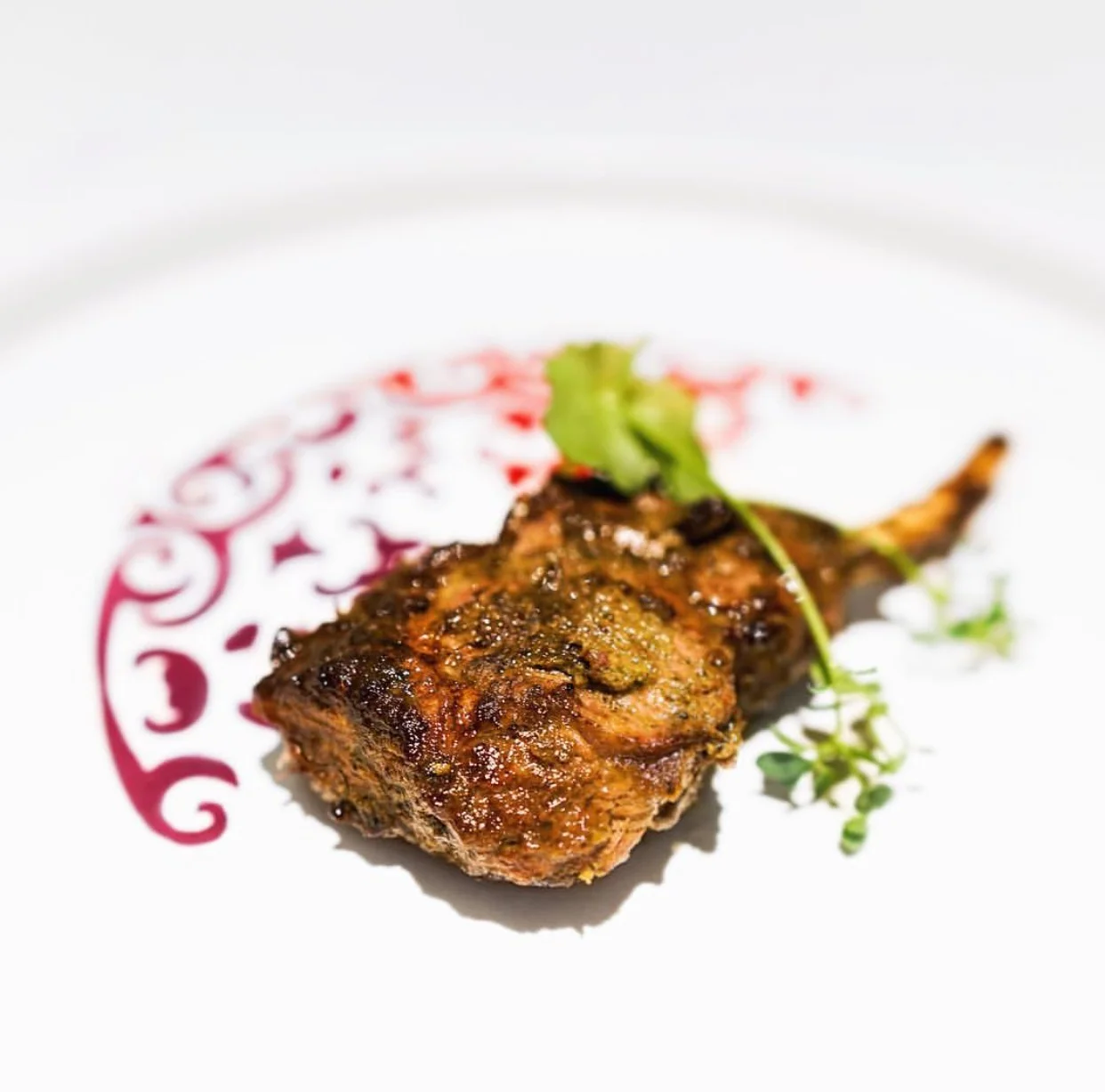 Lamb loin chop cooked sous vide with a penetrating marinating paste finished over charcoal tandoor.