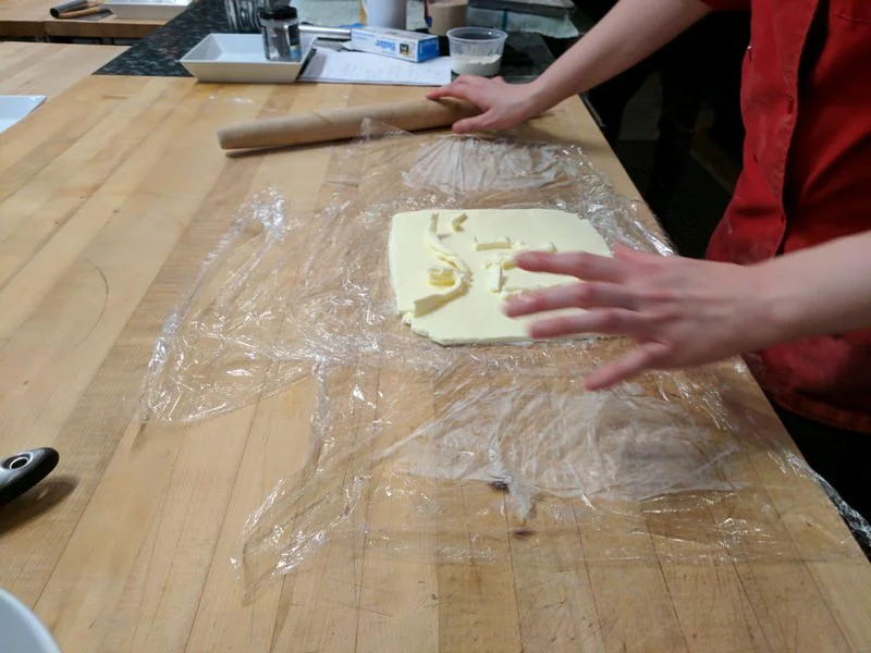 Place trimmed butter pieces back onto the butter block. Wrap the square tightly to keep the block shape and roll one more time to combine. Butter block is ready to fold into dough!