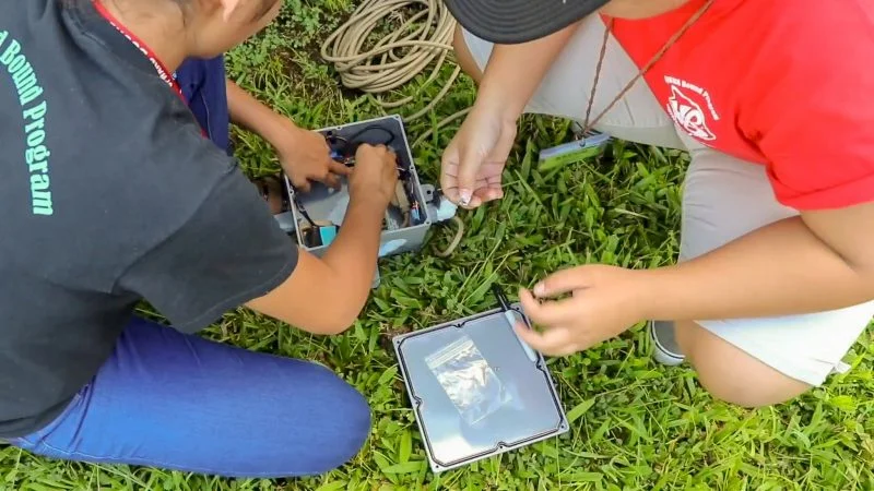 Students from the Teaching Through Technology (T3) Alliance , University of Hawai‘i at Hilo Upward Bound summer program, install an air-quality monitoring station outside the Dragon’s Eye Learning Center on Papaya Farms Road. Photo courtesy of Adam Low, T3 Alliance.