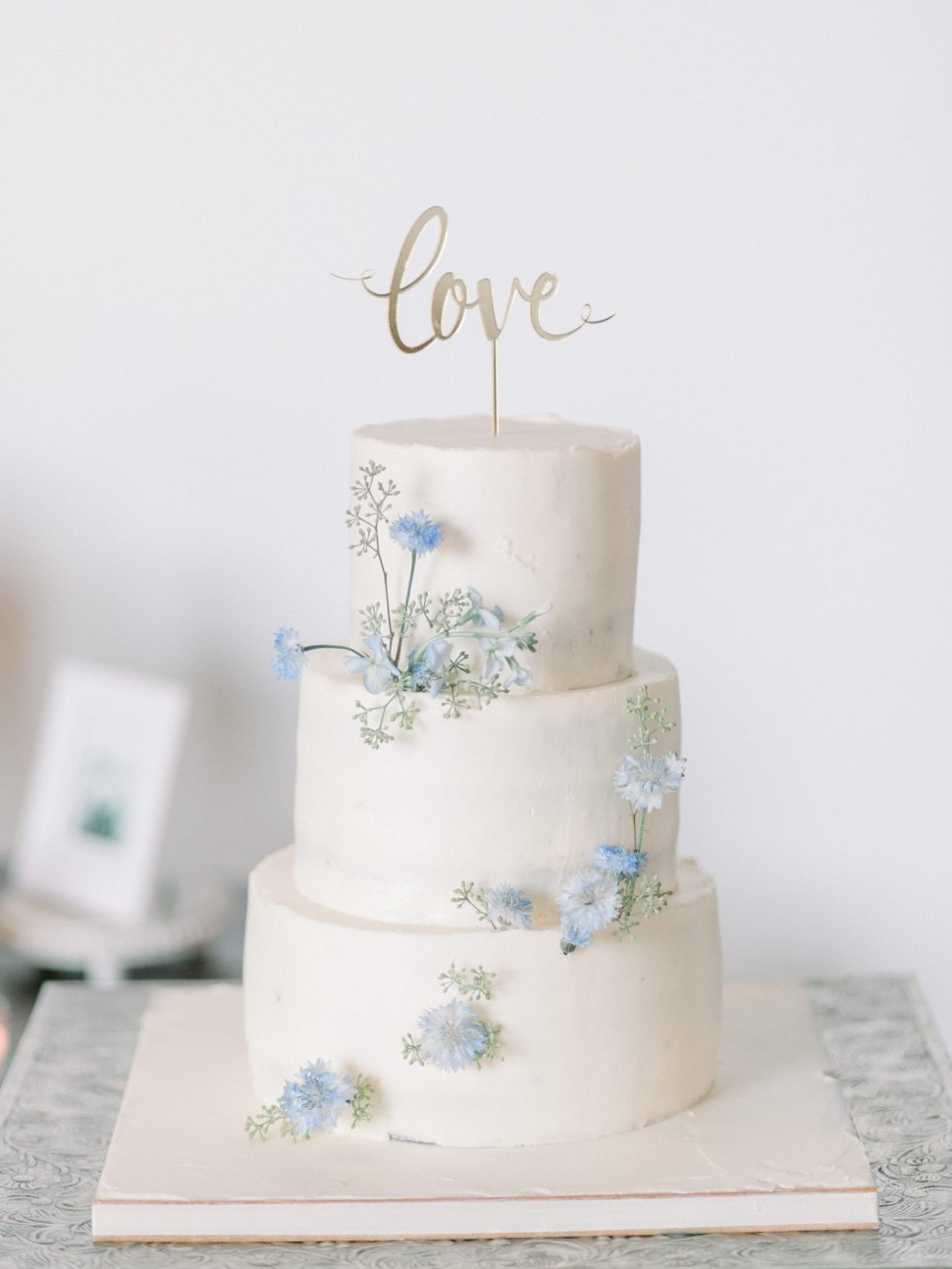 buttercream wedding cake with blue flowers