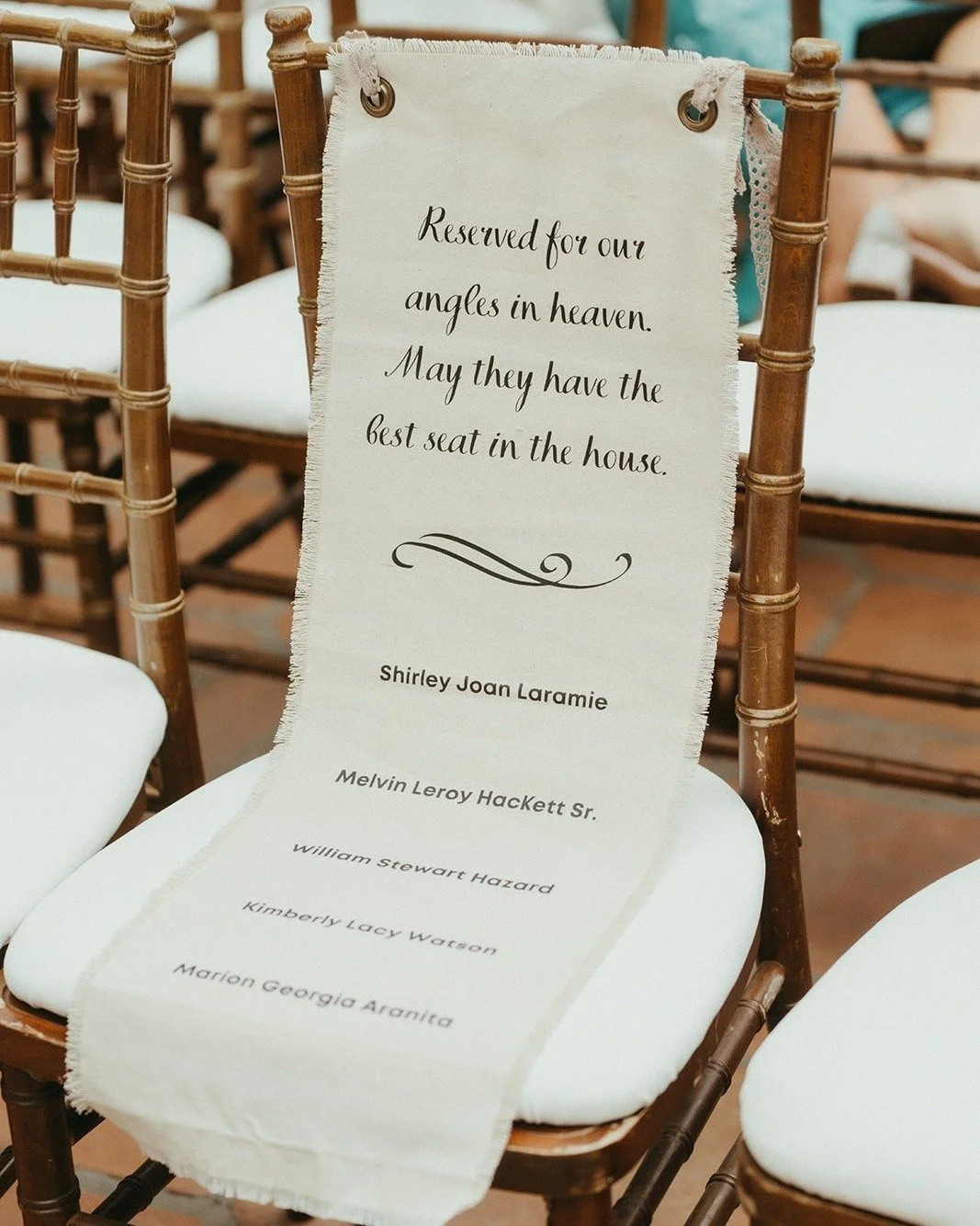 When working on a guest list for a wedding, couples often think about how to include important friends and family who have passed on. 

This banner with a simple but significant message was one of my favorite ways of honoring the departed on the wedd