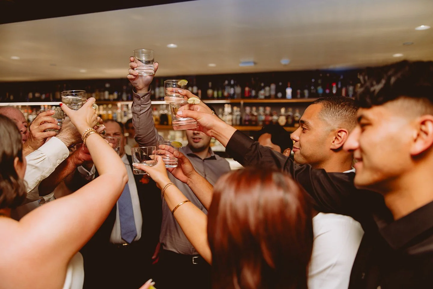 Candid moments like a celebratory toast near the bar are always fun to be a part of (and fun to watch!) at a wedding. These guests cheered for our wonderful couple T+M as everyone danced the night away alongside them!

@birdiegsla @afabsoiree @dartco