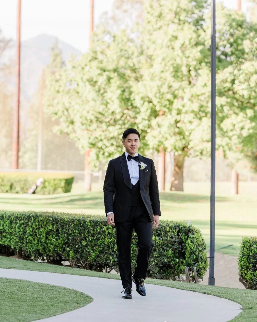 At Almansor Court, you have a couple of choices for your processional walk when getting married at the gazebo. M+D chose the longer pathway because the photos would have a nicer backdrop, and they were right. 

Look at our dapper groom here as he mak