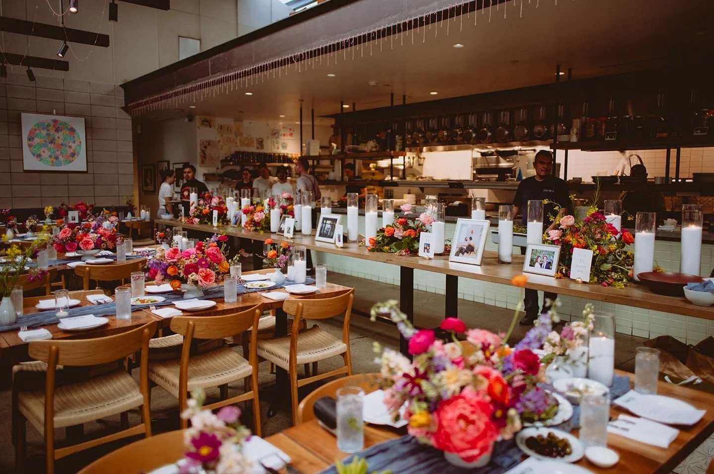 If your venue space has a long table that you're able to use, a fun way to adorn it is by adding photos of yourselves. Some couples will do so in a timeline sort of fashion, bringing guests along with them through the journey of their relationship th