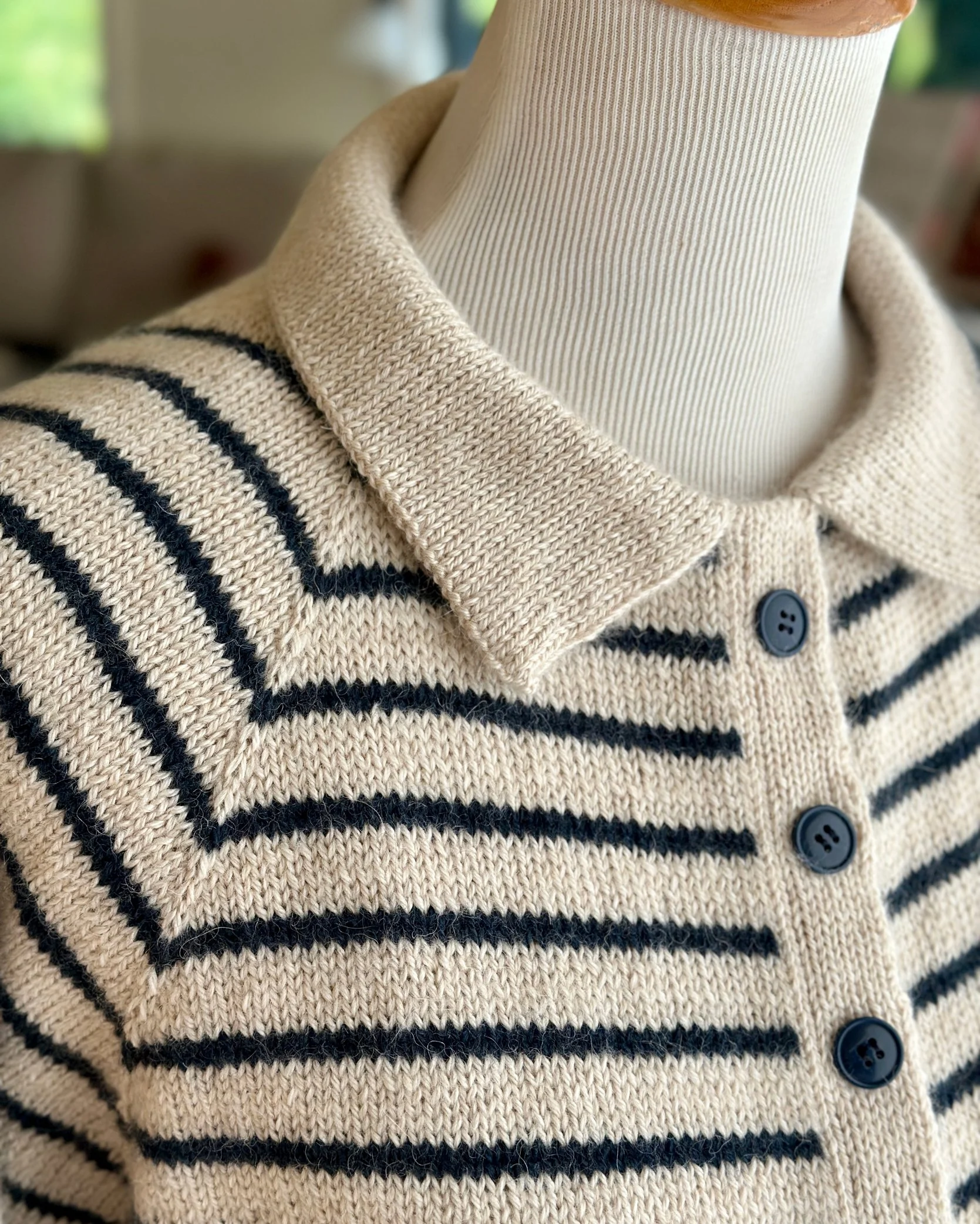 Close up of collar and button placket on King Tides cardigan knitting pattern.