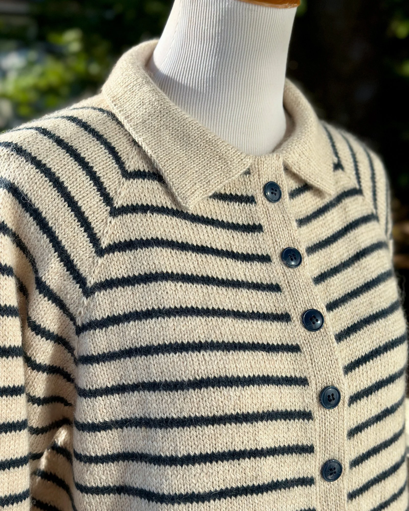 Close up of collar and button placket on striped King Tides cardigan knitting pattern.