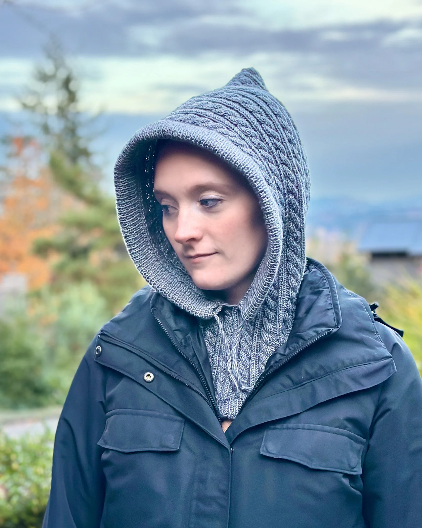 Model wearing grey Tryon Creek Hoodie balaclava with hood up.