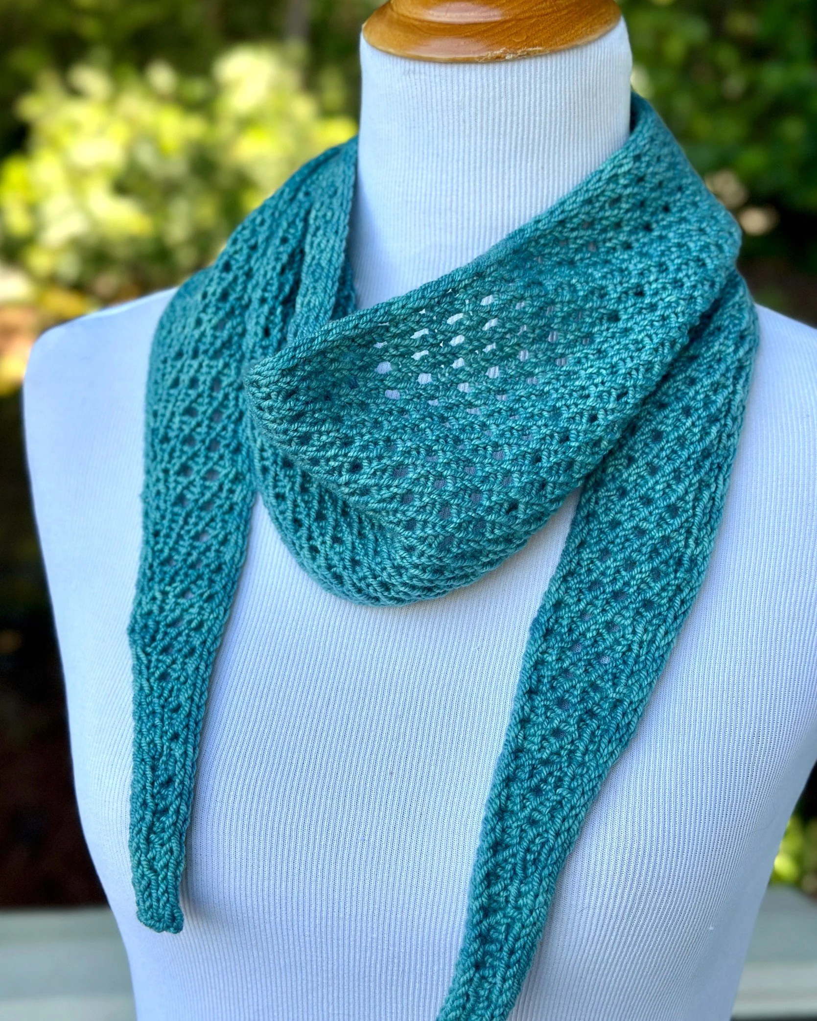Moonbeam Scarf, an easy textured lace knitting pattern, shown here loosely draped around the neck.