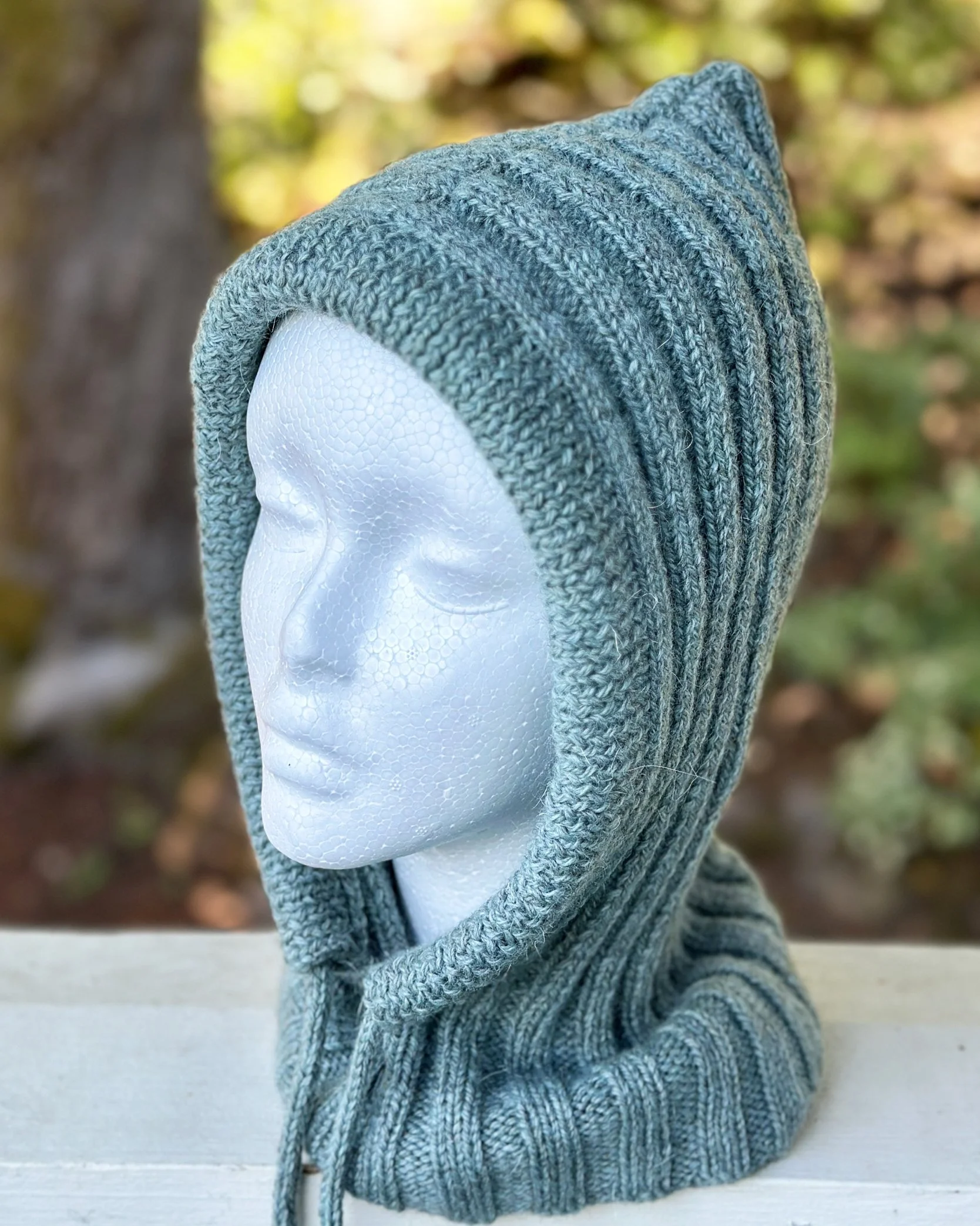 Mt Hood, a balaclava style hoodie knitting pattern with an attached cowl. Choose your tie and wear it both as a cowl and as a hoodie. It's cute even on a mannequin!