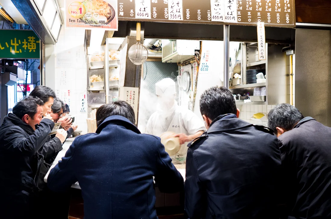  "Salary Men" eating late night meal, Shinjuku Ward, Tokyo, Japan.   