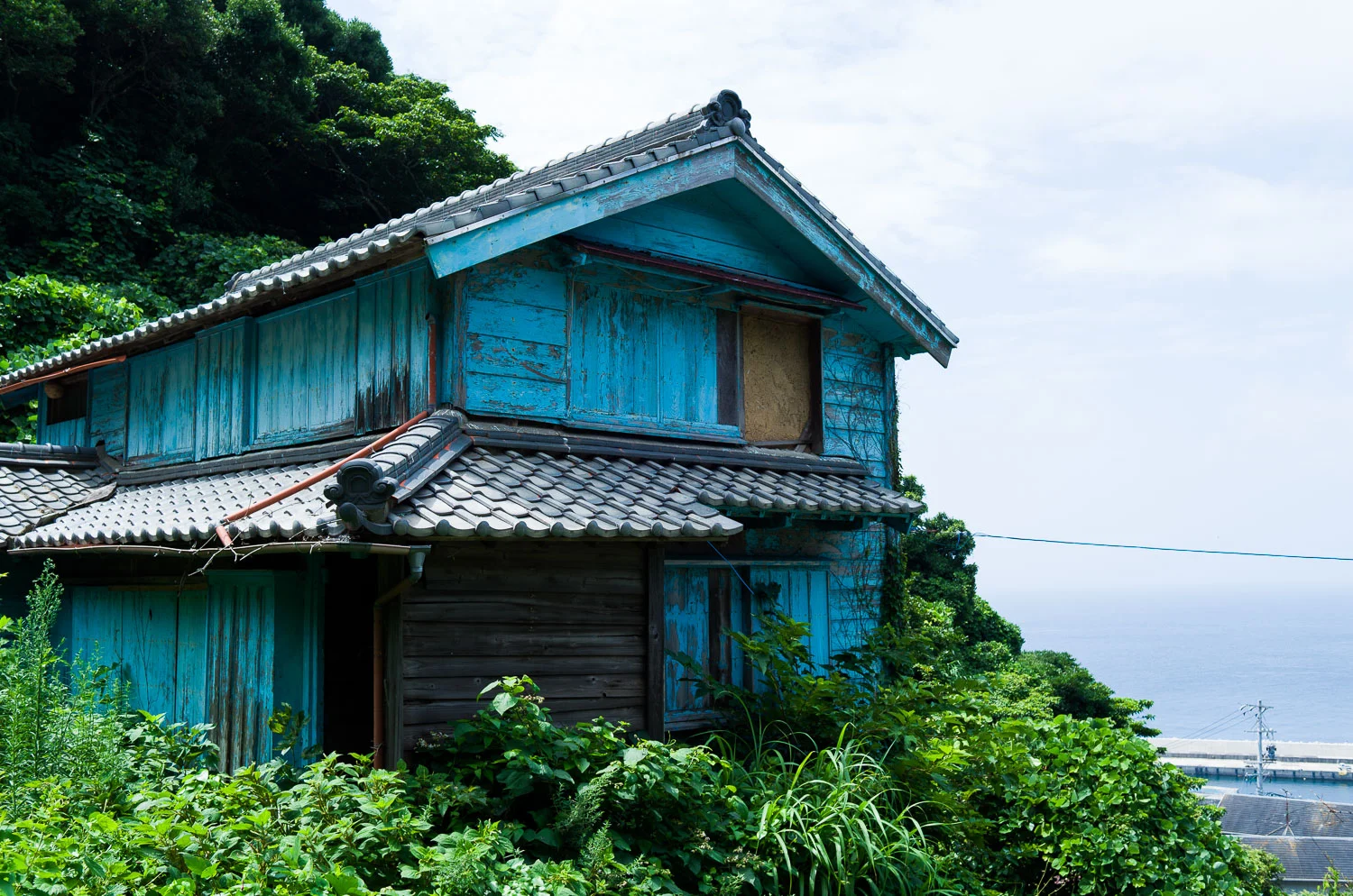  A boarded up home on Kami-Shima island. Many youth forgo Japan’s remote coastal areas today for life in the city.  