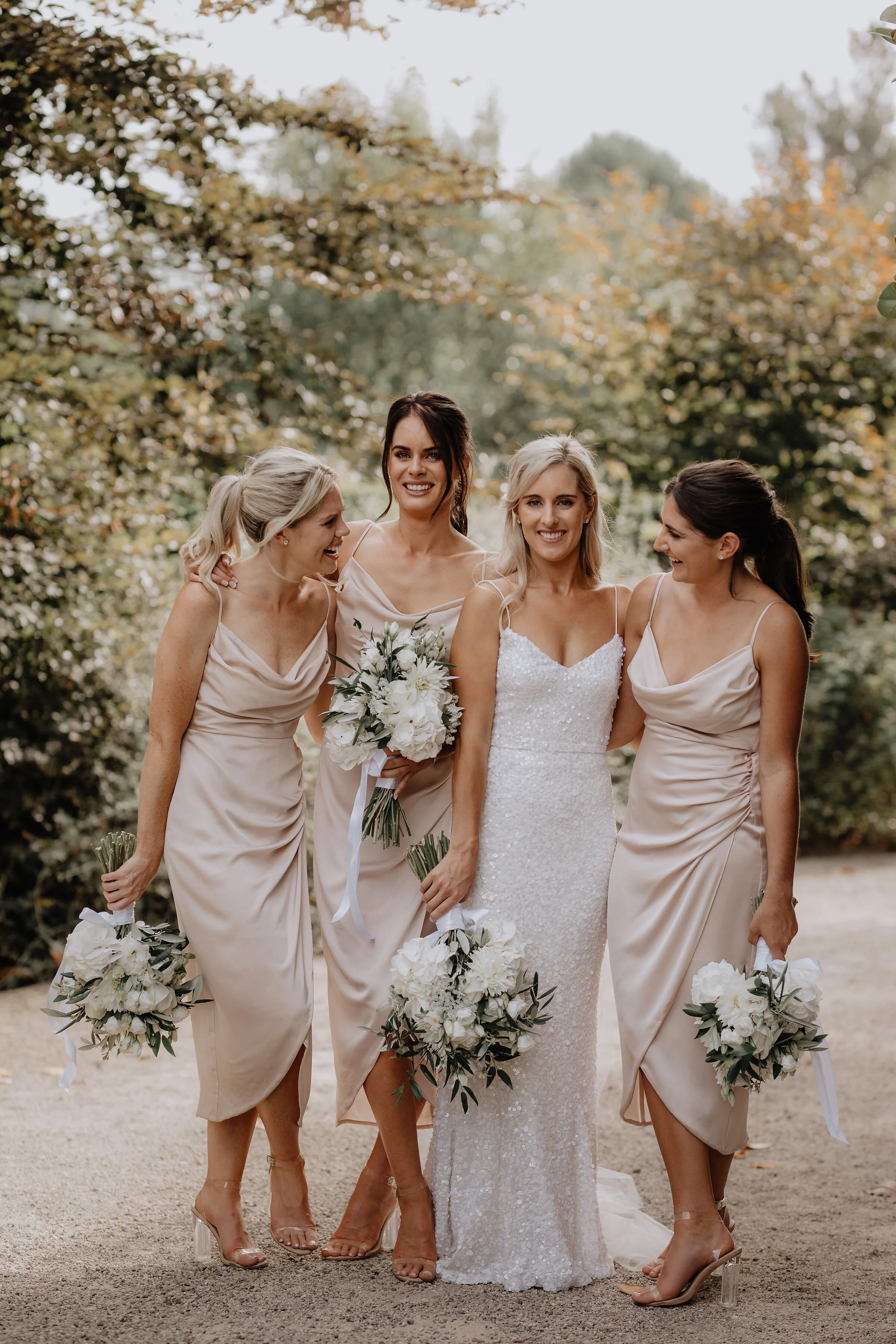 laughing-smiling-bridal-party-holding-white-bouquets-tauranga-ataahua.JPG