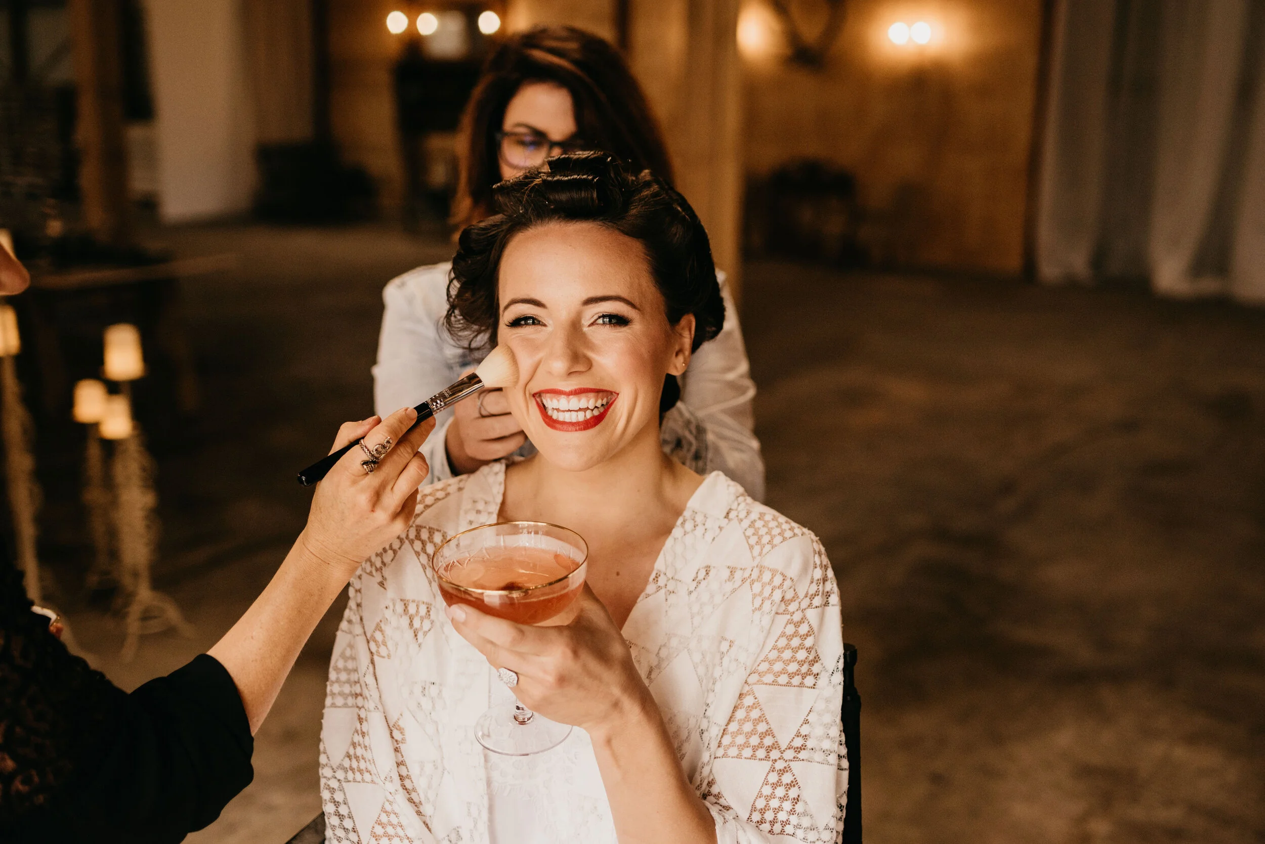 happy-glam-bride-getting-hair-and-makeup-done.jpg